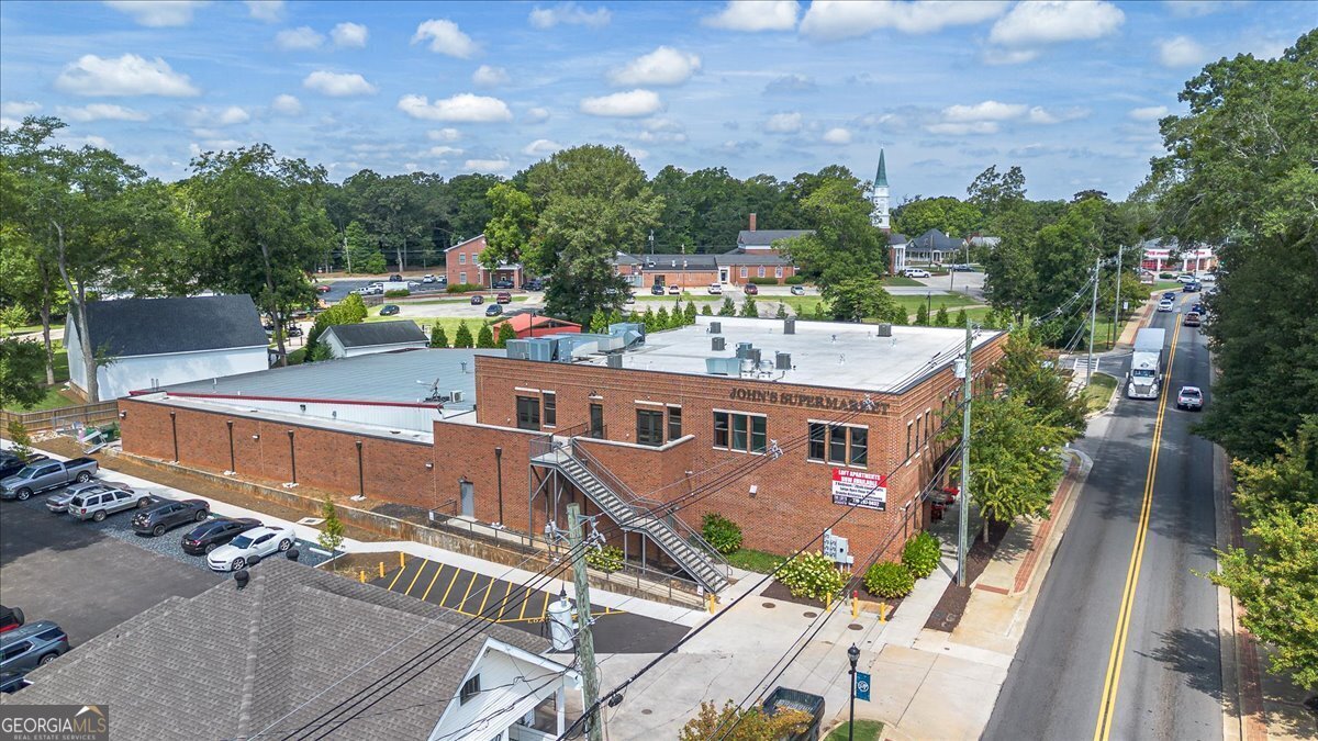 Come experience the best of Downtown Monroe while living at The Lofts at John's Supermarket! Steps away from shopping, dining, and The Town Green, you will love being in the mix of it all! These 2 bedroom, 2 bath lofts are a generous 1350 square feet, complete with granite in kitchen & baths, brand new stainless steel appliances, including washer and dryer, and water is included in your monthly payment. Each of the 6 units feature an open concept floorplan and are filled with natural light, yet well insulated so that you don't hear a peep of the traffic down below! Both bedrooms have their own bath and walk-in closets. Enjoy 2 designnated parking spaces and additional shared space to park your golf cart that you're sure to ride all around town this fall! Each unit's floorplan is unique, so call today to schedule your private tour of each one and decide which one you like best! You will love calling The Lofts at John's home!