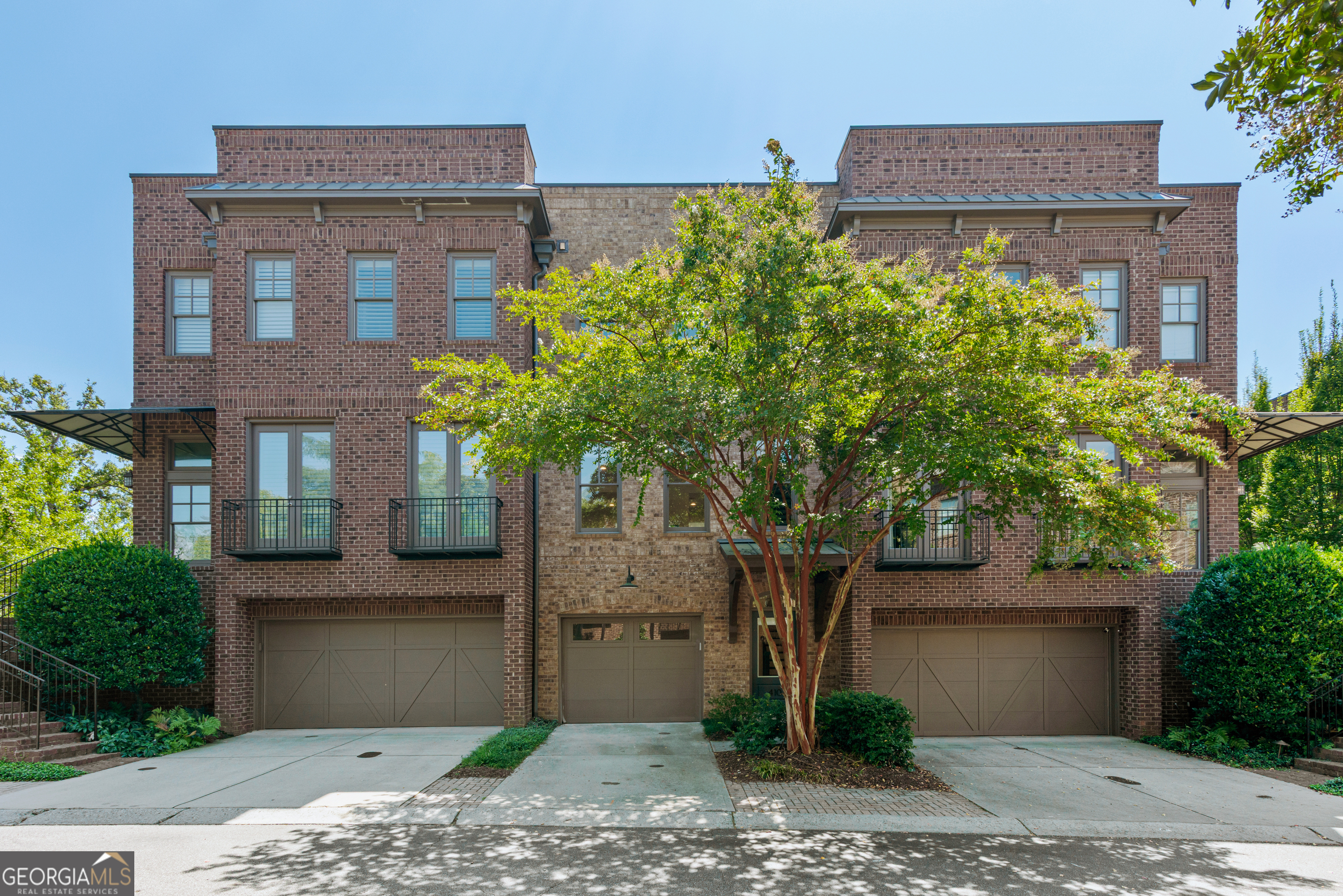 Walkable lifestyle in the heart of downtown Historic Roswell! Gorgeous brownstone just steps off Canton Street in gated Providence. Move-in ready with fresh paint, durable flooring and an easy-living layout. Main level features an open floor plan that allows light fill the entire space. Family room is divided from the dining space by a two-sided fireplace. Kitchen features a center island, gas range, new backsplash, granite counters, a pantry, and plenty of cabinet storage. Kitchen is open to the dining space and to the rear open-air deck, an ideal outdoor sitting space or a place for an herb garden. Upstairs you'll find a spacious primary suite with large, bright windows, a huge walk-in closet, an additional walk-in closet and a large bath with double vanity, soaking tub and walk-in shower. The second bedroom is also suite style with a walk-in closet, and bathroom with a tub, shower and a vanity with plenty of storage space. Laundry room and linen closet is nicely situated between the bedrooms for convenience. The lowest level features an oversized space with a built-in ventless fireplace that could be used as a bedroom, a theater room or a home gym. Large door and windows give a view to the private courtyard space that provides both covered space for sitting and sunny space for a garden. Full bath and space for a walk-up bar complete the lower level. One-car garage provides secure parking with additional parking available in the driveway and designated parking spaces within the gated complex. The community provides you an outdoor pavilion with a stone fireplace, a dog park, and the feeling of being tucked away in a secret corner. While you will love this home, you will truly love the walkable access and lifestyle you'll gain living here. Literal steps from Canton Street means you can join the party when you want, and walk home to peace in minutes. You will love exploring the restaurants and shops. You will love the walkable lifestyle, only a short ways to the River and Riverwalk or to the Roswell Area Park. You will love your neighbors who are friendly, welcoming and who appreciate how lucky they are to live this life. You will truly love living here. These homes are rarely on the market - don't miss your chance, book your showing today.
