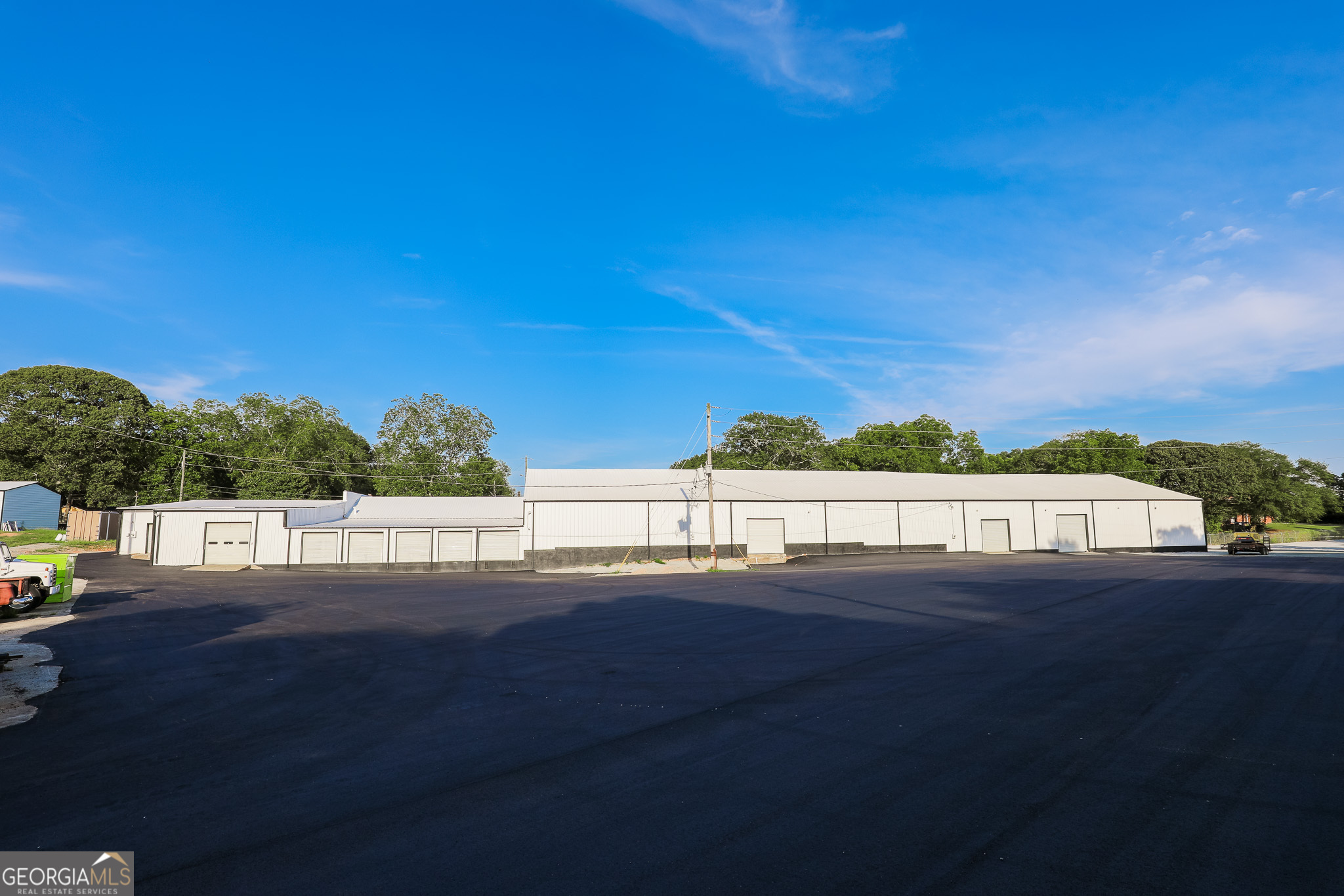3,822 SF warehouse available for lease in the City of Newnan, zoned Industrial Commercial. 1,190 SF office space and 2,632 SF warehouse space. Conveniently located just 2.5 miles from I-85 (Poplar Road exit), this property offers a versatile space suitable for a variety of business needs. Key Features: Total Space: 3,822 SF (1,190 SF office | 2,632 SF warehouse) 5 Roll-Up Doors (8' each) with 8-11ft ceiling heights, Truck Parking on both newly paved and gravel lots Kitchen & 2 Bathrooms for added convenience, Secure Access: Two newly installed gates with keypad entry, Fully Fenced Property with exterior cameras & outdoor lighting, Potential Rail Access for expanded logistics capabilities, Recent Upgrades: Fresh interior & exterior paint, New LED lighting throughout, Granite countertops & sheetrock in office spaces, New awnings, grading, parking, & asphalt New gutters for improved drainage, Additional Space Available: 19,561 SF of warehouse/office space also available for lease Landlord may lease an additional 0.5 acre for parking if needed This is a prime leasing opportunity in a strategic location-ideal for industrial, logistics, distribution, or manufacturing operations.