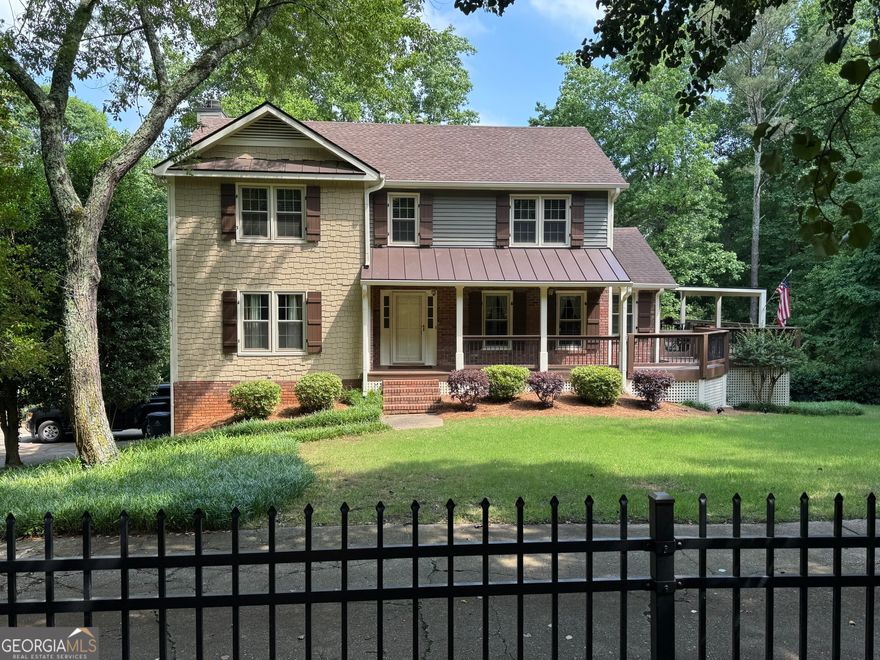 New on the market! Located 5 minutes from downtown Roswell in the Roswell H.S. district, this must-see home has so many great features to offer! Thoughtfully updated throughout with extra moldings and details, the main level offers a spacious front living room/office space with French doors, formal dining room, inviting family room with fireplace and built-ins, sunroom, and eat-in kitchen with granite counters and plenty of great storage spaces. Upstairs, you'll find the master suite with an expanded custom closet, two secondary bedrooms, and newly redone hall bathroom. Enjoy the privacy of this beautiful spacious lot from the screened porch or relaxing in the hot tub, and the large covered deck with metal roof makes a perfect spot for entertaining! The partial basement has a finished flex area with brand new carpet, as well as a large workshop/unfinished area for extra storage. In addition to the 2-car garage, there is plenty of space for additional outdoor parking. The yard is mostly fenced and includes a large storage shed/workshop. All windows have been replaced within the last 3 years. No HOA.