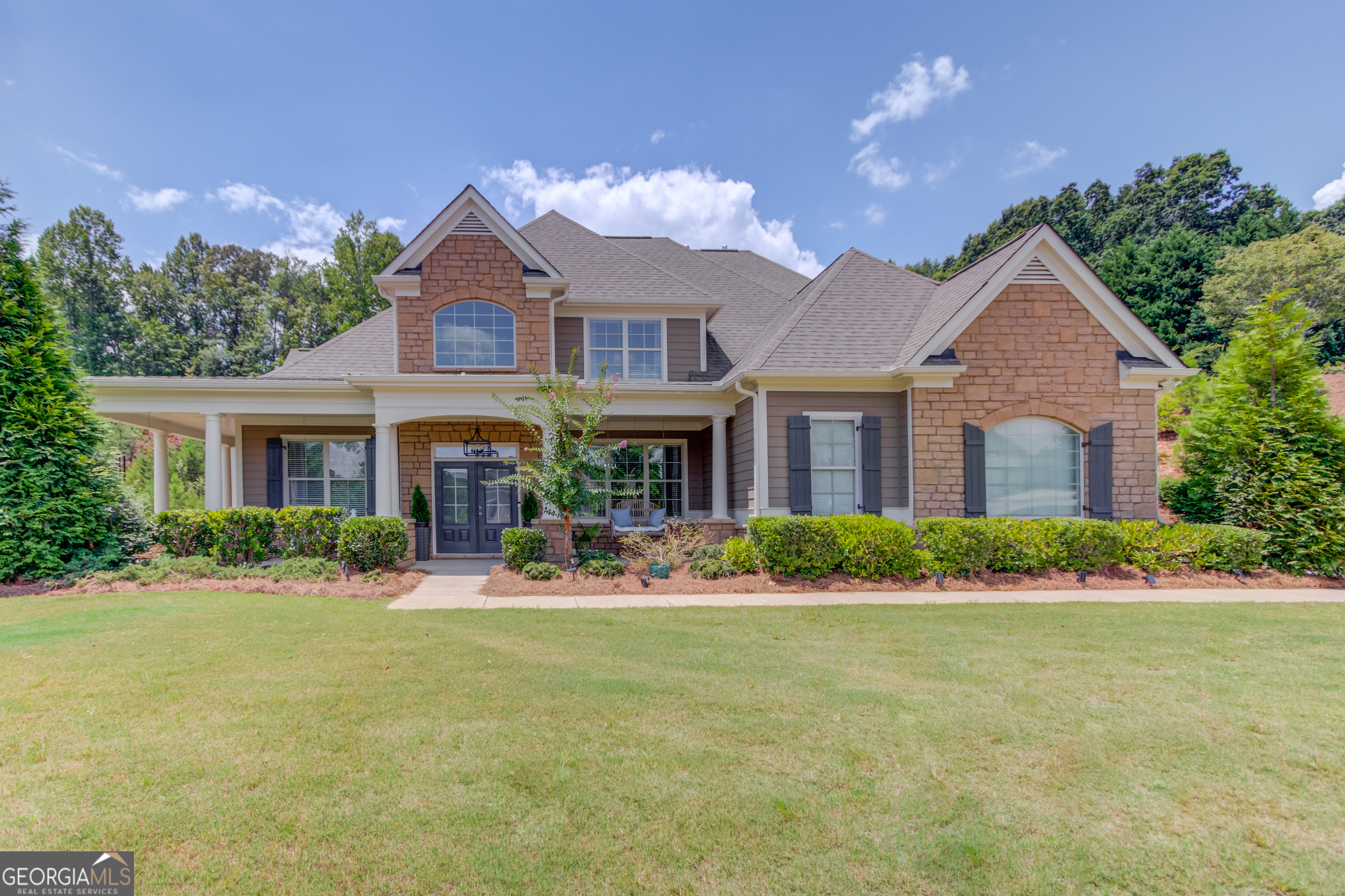 Beautiful 4 bedroom, 3.5 bathroom home in The Shores of Lynncliff located on Lake Lanier in the Chestatee High School District. The main level features a bright and light 2-story entry foyer, office with French doors, open concept dining room, fireside living room with a view to the eat-in kitchen featuring granite countertops, an island, and stainless-steel appliances. The main level also features the owner's suite with a double vanity, shower, soaking tub, and walk-in closet. There is also a half bath, laundry room and 2 car garage with a car charging station completing the main level. The upper level features 3 secondary bedrooms (1 with an ensuite bath), 2 full bathrooms, and a bonus room. This incredible home features a covered, wrap around front porch, fenced backyard with a beautiful stone outdoor fireplace, and a partially covered patio with a fan. The Shores of Lynncliff Community is protected by security gates and features amenities such as a clubhouse, playground, pool, private offsite dry storage for your boat, jet ski, RV's, etc.., and private community dock! Robinson Park is minutes away! Come check out this stunning home and this incredible Lake Lanier community!