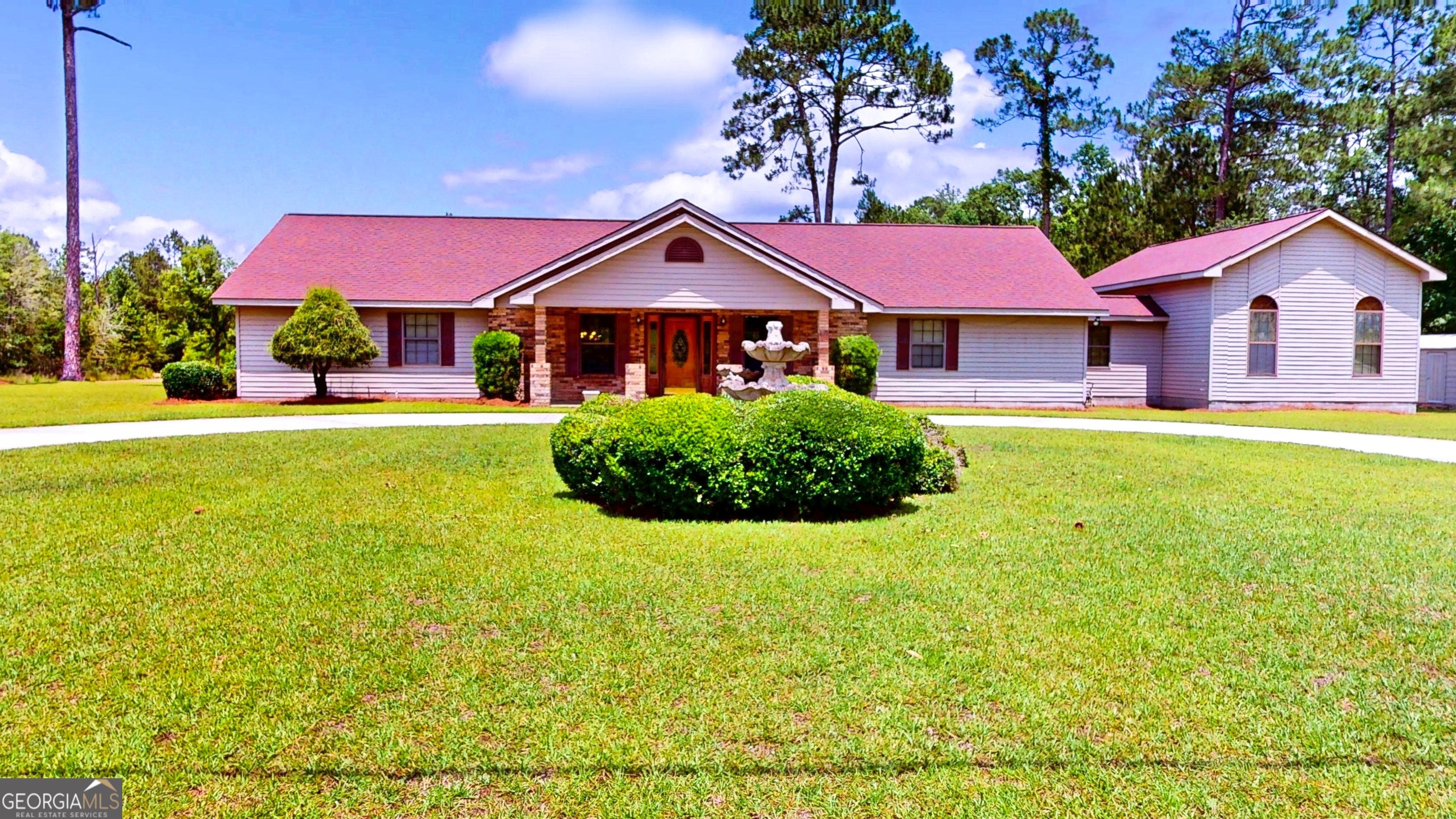 Spacious Country Living on 3 Acres with Private Pond Escape the hustle and bustle of city life in this expansive 3,400+ square foot home, ideally situated on a serene 3-acre corner lot just outside the city limits. This exceptional property offers a unique blend of comfort, space, and outdoor beauty, making it an ideal retreat for families, entertainers, or anyone seeking a peaceful lifestyle. As you approach the residence, a grand circular driveway and a covered carport welcome you. The home's thoughtful design is immediately apparent, with an inviting facade that hints at the warmth and space within. Step inside to discover a large, open-concept family room, dining area, and kitchen. Beautiful laminate flooring flows seamlessly throughout the main living spaces, creating a welcoming atmosphere. The spacious family room is perfect for gatherings, while the adjoining dining area, framed by a charming bay window, offers a lovely spot for meals. The kitchen features tile flooring and opens to the living areas, ensuring the cook is always part of the conversation. This home boasts three generously sized bedrooms and two full bathrooms. The main suite provides a comfortable haven, while the additional bedrooms offer ample space for family or guests to stay. The flooring in the bedrooms is plush carpeting for added comfort. Highlighting the home's accessibility, it is also ADA compliant. One of the standout features of this property is the expansive third bedroom, a versatile flex space that can be tailored to your specific needs. With its private exterior entrance and a lovely deck overlooking the picturesque backyard and pond, this room is perfect for a home office, a personal gym, a man cave, or a creative crafting room. The outdoor space is truly a private oasis. The sprawling 3-acre lot offers ample space to roam, play, and unwind. The highlight is a beautiful pond complete with its dock, offering a tranquil spot for fishing or simply enjoying the peaceful sounds of nature. Don't miss this rare opportunity to own a substantial home with abundant land and desirable amenities. Schedule your private tour today and experience all that this remarkable property has to offer! Call Tanya Lane at 912-536-1454.