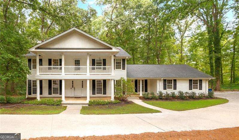 Experience timeless elegance and serenity in this private Colonial retreat nestled on 1.82 acres with a stately, long circular driveway. From the moment you arrive, the home radiates serenity and understated sophistication. Inside, you'll find 5 spacious bedrooms and 4 full baths, thoughtfully designed with heated flooring for year-round comfort. The main level provides multiple living areas, perfect for both everyday living and hosting gatherings. The kitchen is a true centerpiece, featuring double ovens, abundant cabinetry, a walk-in pantry, and space to inspire culinary creativity. Also on the main level are like-new 3/4 inch red oak hardwoods that add warmth and character - truly a rare find in homes today. The fully finished daylight basement is an entertainer's dream - complete with a large media/bedroom, a flex room, a Pool room with a fireplace, and even a second kitchen. Whether you envision game nights, guest accommodations, or multi-generational living, this level adapts to your lifestyle. And with exceptionally low utility costs (ask for details-you'll be truly amazed!), this home is as practical as it is beautiful. Step outside to either the spacious balcony or back deck, where you can unwind while soaking in the natural beauty, wildlife, and harmony of your surroundings. The property is situated within a small neighborhood of homes on acreage, offering both privacy and community. Prime Location, Top-Rated Schools: Just 5 miles to I-85 and the Mall of Georgia, offering endless shopping, dining, and entertainment, and only 1.9 miles to Hwy 316/29, making commuting a breeze. Zoned for excellent schools at every level, adding long-term value for families. This home is more than a place to live-it's a rare combination of elegance, comfort, privacy, and convenience-a true must-see for buyers seeking a home that balances tranquil living with unbeatable accessibility.