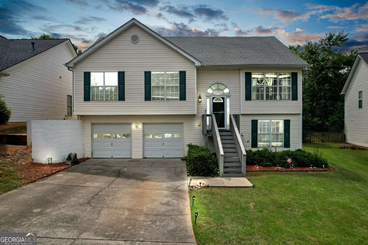 Welcome to this charming split-level home in the desirable Liberty Commons neighborhood! This home features an open and bright floor plan with vaulted ceilings and hardwood floors throughout the main level. The updated kitchen boasts granite countertops, stainless steel appliances, and plenty of storage - perfect for cooking and entertaining. The oversized primary suite offers a peaceful retreat with a spacious bathroom featuring a soaking tub and separate shower. Two additional bedrooms and a full bath complete the main level. Downstairs, enjoy a large finished daylight basement with a media room, an extra bedroom, full bathroom, and convenient laundry area. The basement has both interior and exterior access to the fully fenced backyard with a spacious deck - ideal for relaxing or hosting gatherings. Liberty Commons offers fantastic community amenities including a pool, tennis and pickleball courts, playground, dog park, walking trails, and clubhouse. This home is conveniently located near Cobb Parkway and North Cobb High School, putting shopping, dining, and top schools within easy reach. Don't miss the chance to make this well-maintained, move-in ready home yours!