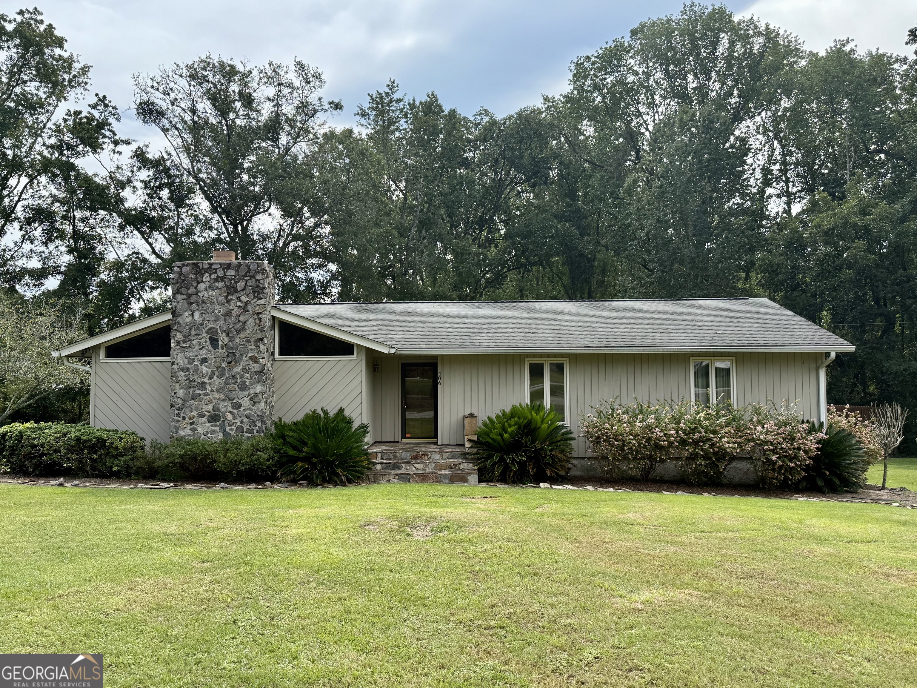 Welcome to this beautiful 3-bedroom, 2-bath home situated on a spacious 1.6-acre lot just around the corner from the Forest Heights Country Club. Perfect for entertaining and everyday living, the property features an inviting in-ground saltwater pool with a large deck and a relaxing porch that overlooks the private backyard. Inside, the living room impresses with tall wood-beamed ceilings, abundant windows that fill the space with natural light, and a striking stone fireplace. The open layout flows seamlessly into the dining area, creating a warm and welcoming atmosphere. The kitchen boasts stainless steel appliances, a breakfast bar, and plenty of workspace for everyday meals or gatherings. The master suite offers a peaceful retreat with a spacious walk-in closet, double vanities, and ample storage. Two additional bedrooms and a full bath complete the layout, providing comfort for family or guests. With its combination of classic charm, and resort-style outdoor living, this Statesboro property is a rare find!