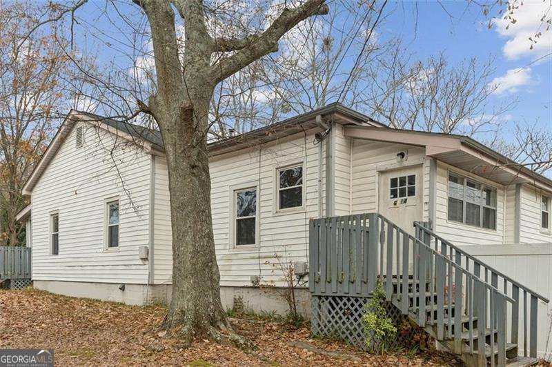 Welcome to this 3-bedroom, 2-bathroom home full of character and timeless charm. Featuring original hardwood floors and a thoughtful mix of updates, including a modern kitchen and bathrooms, this home is ready for someone to make it their own. The spacious backyard is perfect for relaxing, entertaining, or creating your dream outdoor space, and the extra parking pad adds convenience for guests or multiple vehicles. Located just a short walk to Mill Village Park and close to downtown Douglasville, shopping, and major highways, this home offers both charm and accessibility. Whether you're a homeowner looking for a special place to put down roots or an investor searching for your next project, this property is an incredible opportunity. Bring your vision, a little TLC, and turn this house into a true showpiece!