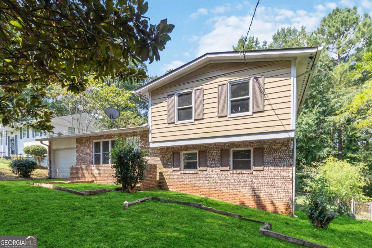 Nestled in a quiet well established neighborhood, this 4-bedroom, 2-bath property is the perfect canvas for your vision. Whether you're an investor searching for your next addition to your portfolio or a homeowner ready to gain sweat equity, this fixer-upper is full of potential. Inside, you'll find an open layout starting with a bright living room filled with natural light, original hardwood floors, spacious bedrooms upstairs, a large flex space on the lower level and tons of storage. Step outside to a generous backyard with covered deck and endless possibilities for outdoor living-create a private retreat, garden, or play area. A garage and ample driveway parking add to the convenience. Close to public transportation, schools, shopping, and dining, this home offers both location and opportunity. With updates, it can be transformed into a beautiful home or profitable investment. Don't miss your chance-schedule a showing today!