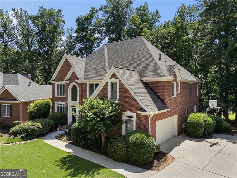 REDUCED PRICE! Welcome to refined living at its finest in this beautifully updated 6-bedroom, 5-bathroom residence, offering nearly 4,500 square feet of thoughtfully designed space across three finished levels. Set on a large, private lot with lush new landscaping, this home delivers the perfect blend of modern luxury and timeless charm in an established neighborhood setting. From the moment you step into the expansive, light-filled foyer, you'll be greeted by soaring ceilings and fresh paint throughout. A formal sitting room to the left and an elegant dining room to the right create a warm, inviting welcome, while the open-concept living room just ahead draws you into the heart of the home. The brand-new kitchen is a showstopper-fully renovated with all-new cabinetry, appliances, and countertops. A breakfast area and coffee bar with its own wet sink and beverage cooler make mornings a pleasure. Just off the kitchen, a partially screened, partially open-air deck offers an ideal space for outdoor entertaining, while the walk-out basement patio below provides a seamless connection to the peaceful backyard. Upstairs, four spacious bedrooms await, including the oversized primary suite-complete with a sitting area, walk-in closet, and luxurious en suite bath. An additional en suite bedroom and a Jack and Jill setup ensure comfort and privacy for everyone. The fifth bedroom is located on the main level, and the sixth sits on the fully finished terrace level, which also includes a full bath and generous storage areas-perfect for a media room, home gym, or in-law suite. Recent upgrades include a brand-new kitchen and bathrooms, all-new paint, freshly sanded and sealed hardwood floors (2025), new appliances, a 3-year-old roof, a 4-year-old garage door, and a 6-year-old A/C system. Three sides brick, elevated ceilings, and a thoughtfully designed layout make this home as functional as it is beautiful. Every detail has been considered-this is the one you've been waiting for. this home offers a rare combination of comfort and convenience. With proximity to downtown Alpharetta, Avalon, and top-ranked public schools,