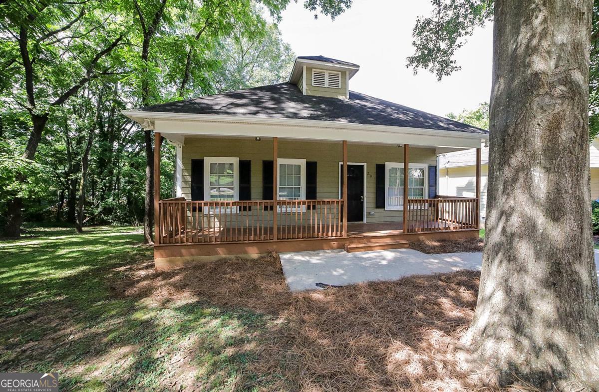 Convenient to Downtown Athens & UGA, this refreshed, in-town cottage is the perfect blend of an easy-living location, and move-in ready condition. DETAILS: *3 Bedrooms/2 Full Bath *1380+/- SqFt. *Year Built - 2006 *Low Maintenance .12 Acre Lot. SPECIAL FEATURES: -ALL NEW Interior Paint -ALL NEW Plush Carpet -9ft. Ceilings -Luxury Vinyl Flooring -Cordless Blinds Package. FLOOR PLAN: -Open, Living/Dining Plan. -Once inside, the oversized Living Room greets you with a refreshed interior full of natural light. -The living space effortlessly overflows to the Eat-in Kitchen, crafted with a spacious dining area complete with double window. -Additional dining space is provided with the extended raised breakfast bar that could easily seat 4+. Quite spacious, the Kitchen features expansive wrap-around counters, an abundance of white cabinets, accompanied by brushed-nickel hardware, perfect for max storage options, double-basin stainless sink, and complete appliance package. APPLIANCES: ~Stainless Smooth top Stove/Oven combination ~Stainless Dishwasher ~Refrigerator. -The Kitchen also offers access to the Laundry Closet, as well as the Rear Porch. -Spanning the left side of the home are 3 cozy Bedrooms each with NEW carpet flooring, ample closet space and quick access to Hall Bath. -Tucked away off the Kitchen, is the Primary Bedroom offering additional space, a second closet and a private ensuite full bath. EXTERIOR: ~Covered Rocking Chair Front Porch expanding the length of the home. ~Covered Rear Porch. ~Concrete Drive/Parking Pad and Walkway. EXTRAS: -Public Water and Public Sewer, -All Electric Systems, -Hardi-plank siding. LOCATION: -Less than 2 miles to East Athens shopping and restaurants. -Within 4 miles to Dooley Field at Sanford Stadium. -Quick access to Loop 10. This standout, in-town bungalow provides the perfect opportunity for your next investment to add to your portfolio, student housing, rental, downsizing-the versatility just adds to the desirability!