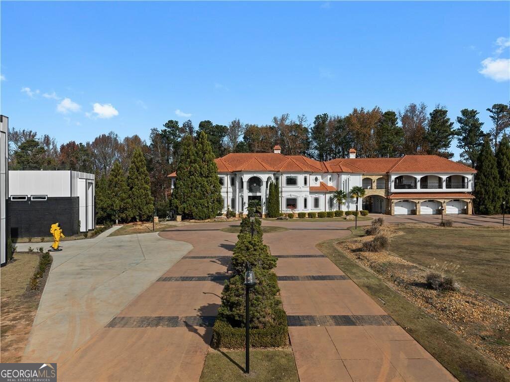 Welcome to 5096 Stephens Road, Gainesville, GA, a rare and extraordinary estate spanning 6.36 acres in one of North Georgia most sought-after locations. This property offers not just one, but TWO distinct luxury residences stunning European-inspired main home and an expansive 9,300 sq. ft. recreational complex, creating a one-of-a-kind living experience that blends sophisticated elegance with resort-style amenities. The main residence is a masterpiece of craftsmanship, featuring exquisite details like ornate wood trim and handcrafted steel railings. Designed for both grandeur and comfort, this home offers multiple sitting and living areas that provide versatility for hosting, entertaining, or simply enjoying everyday luxury. The gourmet chef's kitchen is outfitted with top-tier appliances, granite countertops, and custom cabinetry, setting the stage for culinary excellence. Beyond the main home lies an exceptional recreational complex, unlike anything on the market. This 9,300 sq. ft. entertainment space boasts a two-lane bowling alley, an indoor basketball court, an indoor swimming pool, and multiple recreation rooms, making it the ultimate retreat for both intimate gatherings and large-scale entertaining. Whether you want to host an executive meeting , entertain, or workout, this space has unlimited possibilities, Step outside into your own private oasis, where an in-ground lagoon-style pool, spa, and lazy river offer a resort-style experience in the comfort of your backyard. The expansive patio, outdoor basketball court, and meticulously landscaped grounds enhance the exclusivity of this estate, creating a sanctuary designed for both relaxation and recreation. This remarkable property presents an unmatched value, priced at more than $500,000 below its recent appraisal, offering an incredible opportunity for the next owner to come in and infuse their own personal touches. With two fully equipped residences, this estate provides the rare opportunity to own two luxury properties for the price of one. Located just moments from Lake Lanier and Gainesvilles premier luxury developments, this home is a true masterpiece in one of Georgia most desirable areas. From its architectural grandeur to its world-class amenities, this estate is a rare offering that will exceed even the highest expectations.