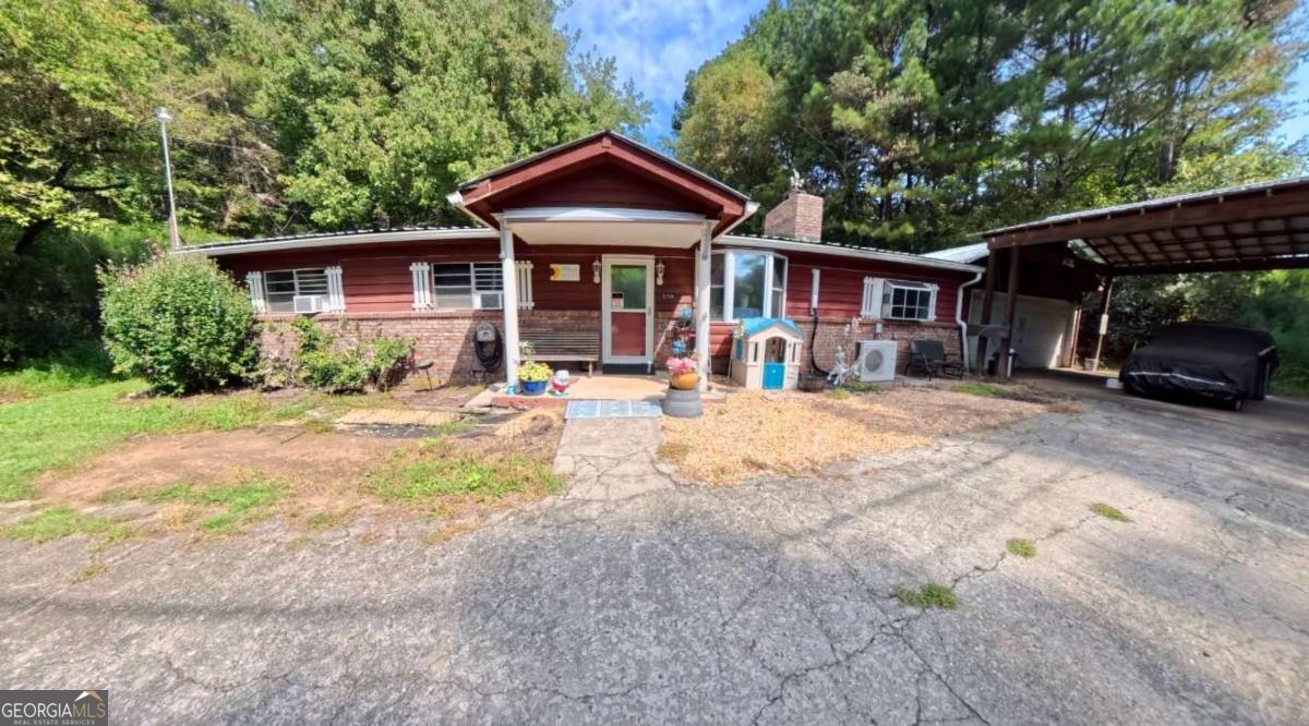 Motivated sellers! Please note no showings until the property is under contract due to family circumstances, unless approved by the sellers. Welcome to this charming 3 bedrooms, 2 bathroom home nestled in a peaceful country setting just minutes from downtown Ellijay, apple orchards, dining, and shopping. Set on 1.84 acres, the property features a wraparound driveway, a covered parking awning, and a garage with an additional storage room- perfect for vehicles, tools, or hobbies. Inside, the home offers a warm cottage-style with timeless wood accents. A separate den or family room provides versatile living space for entertaining, working, or relaxing. Enjoy the outdoors from the large screened in back porch, overlooking a fenced backyard ideal for pets, play, or gardening. This property blends comfort, character, and convenience, offering true country living close to everything Ellijay has to offer.