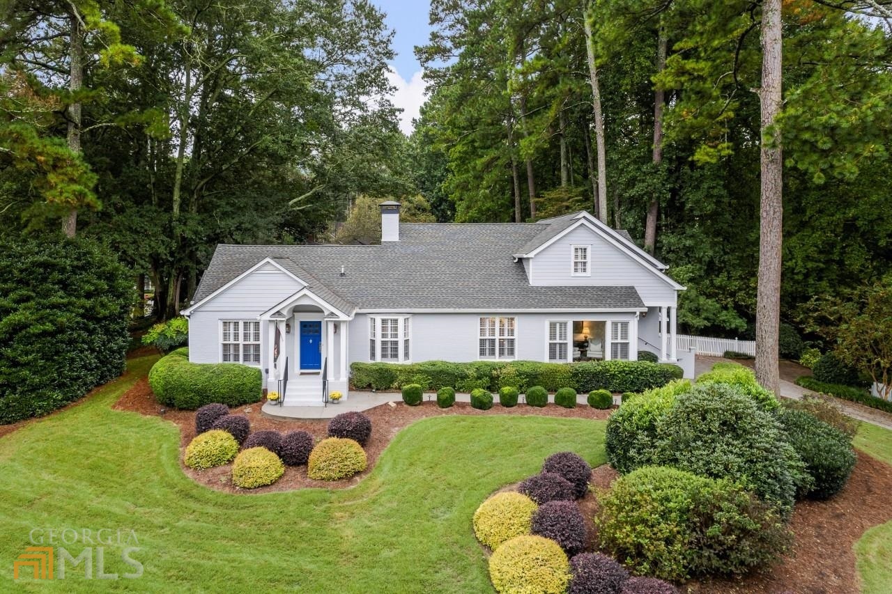 Remodeled to perfection, this traditional beauty is poised perfectly on top of a hill directly facing the desirable Memorial Park with its fantastic playground, new sidewalks, nature trails, audubon bird sanctuary, & open green spaces surrounded by award-winning trees. Foyer opens to the fireside family room, dining room & cozy sunroom with new flooring & covered side porch for convenient driveway access. Heart-of-the-home fully remodeled chef's kitchen with quartz counters, subzero refrigerator, gas range, 2 warming drawers, & a new wine fridge. Pantry AND large storage room with laundry hook ups on main - never skimp on the Costco run! Breakfast bar opens to breakfast room and access to the NEWLY remodeled outdoor living space featuring Pennsylvania Blue Stone paver patio, firepit, & private garden all nestled amongst the lush landscaping. Gated and fenced side yard for additional outdoor adventures. Two spacious bedrooms & full bathrooms on main. Upstairs loft is perfect for a small home gym, office or kids play. 5 Star hotel worthy oversized owner's retreat with vaulted ceilings, private seating area, & massive cedar plank shiplapped walk-in closet with second laundry hook ups in adjoining hall closet, Luxurious bath featuring double marble vanity, garden tub and steam shower. Fourth bedroom is the perfect ultra private home office, craft room or kids playroom. Great schools including Brandon Elementary, easy access to downtown, Northside Beltline Trail, Buckhead, and all major highways. Walk to Bobby Jones Golf Course.