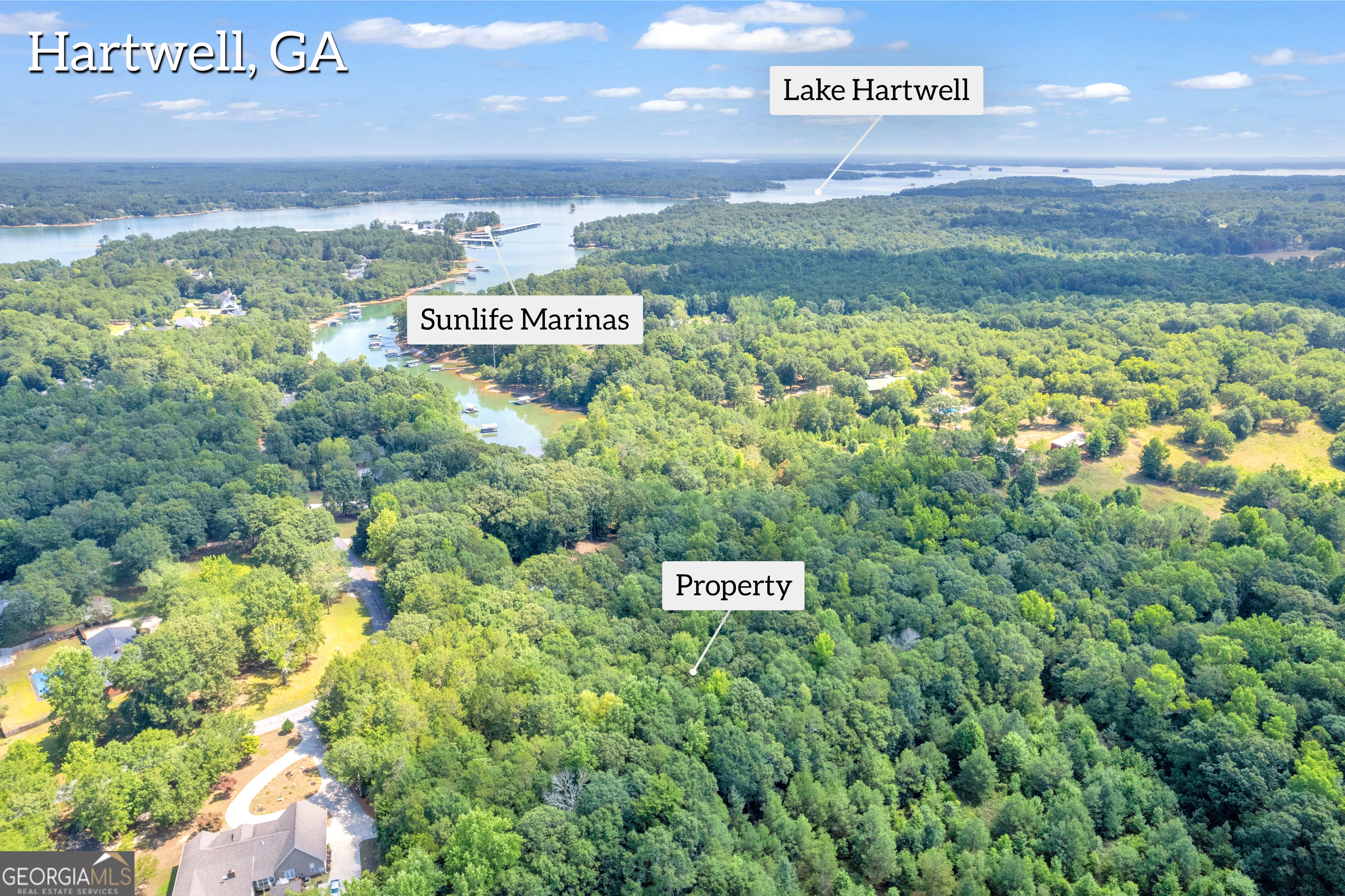 Welcome to your private wooded retreat on Lake Hartwell! This expansive 4.5-acre lot offers exclusive lake access with 550 feet of Corps of Engineers frontage. A (sometimes dry) creek bed winds through the property, feeding into Lake Hartwell. The entire property is a natural habitat for abundant wildlife. Enjoy the peace and tranquility of this secluded haven, ideal for nature enthusiasts and those seeking a quiet escape. The property is protected with minimal building restrictions, no mobile or modular homes, at least 1200 sf, allowing for creative freedom in your construction plans, while ensuring it remains a single, undivided parcel. This unique opportunity to own a slice of nature's paradise awaits you. The property is not dockable, yet easy direct access for canoe, kayak and more! Lake Hartwell is visible through sparce trees and building near the corps-line - near that jagged property line - would offer great seasonal views and year-round with minimal clearing, based on corps guidelines. Soil test complete at multiple locations and available. Lot lines are well-marked. Driveway/path extends full upper length of property. Numerous deer trails, property is quite open of underbrush and easily walkable. Survey available. Map to 414 Winding Way, Hartwell, GA 30643. This driveway is just before Lot G and property borders their wooden fence. Lot: Wood Fence along Top/Short West border, Barbed Wire Fence along Long/Far South border, Corps-Line entire Bottom/East (jagged) border, property markers along North border from road to corps-line. Numerous pink markers indicate soil site work.
