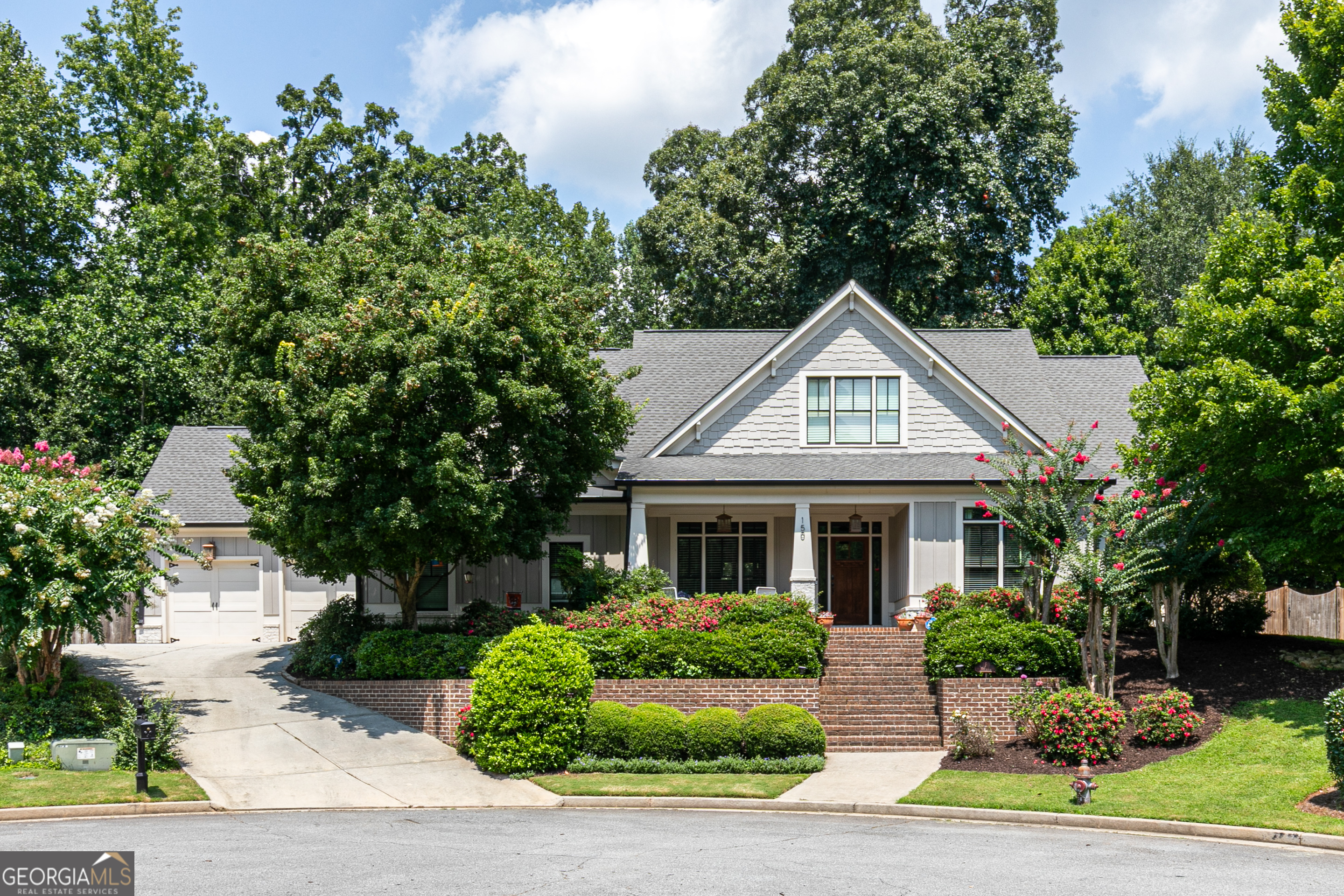 Beautiful, well maintained, centrally located East Cobb home. Originally the model home for the development with executive trim and finishings throughout. Master on main with large master bath with seperate shower and jacuzzi tub. Plus a secondary bedroom on the main floor. Open floor plan with a formal dining room. Large kitchen overlooking a family room big enough for plenty of seating and surround sound throughout. Upstairs you'll find 2 more bedrooms, a bath, and a loft area that can be used as an extra living area or a bedroom if needed. Welcoming covered front porch large enough for extra seating. Covered back porch with expanded concrete to enjoy outdoor living. All of this plus a 3 - car garage that offers plenty of storage. Less than 5 miles to the Atlanta Braves Baseball Stadium, and SunTrust Battery for shopping and dining! Centrally located with immediate access less than a mile to I-75 North/South (Easy access to the Express Lane). Less than 5 minutes to I-285, and 10 minutes from GA 400 North/South.