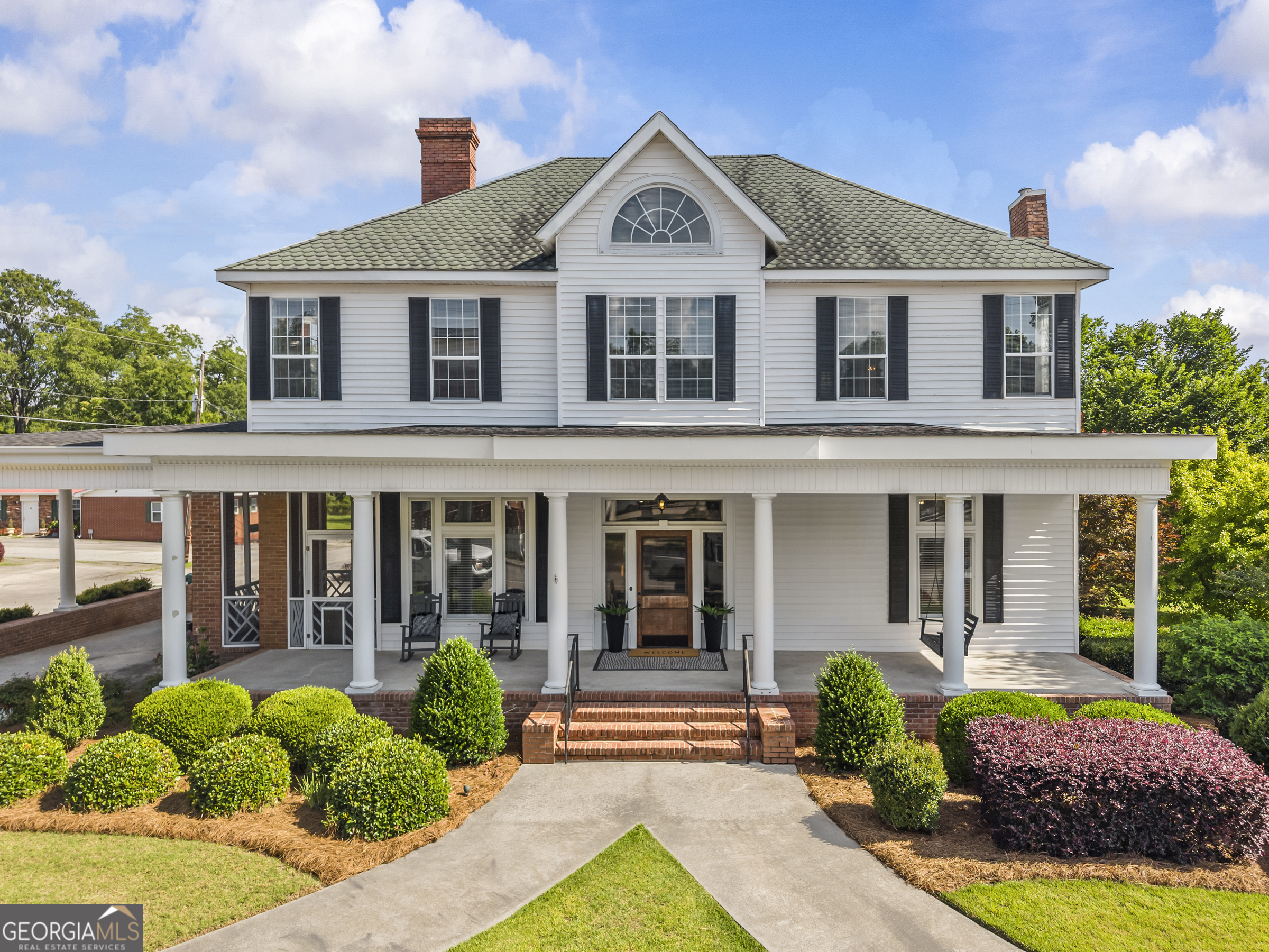 The Wilhoit Family Home: A Story of Legacy, Leadership, and Southern Grace. Built Circa 1907, The house itself is an architectural gem, blending the elegant intricacy of Queen Anne design with the symmetrical poise of Colonial Revival. Perched with quiet dignity beside the historic Warren County Courthouse in the heart of town, the Wilhoit Family Home has stood for more than a century as both a cornerstone of the community and a proud symbol of enduring Southern heritage. The house remains in the hands of the same family that first dreamed it into being-a rare and remarkable continuity that spans four generations. Inside, Each mantelpiece tells a story, with one in particular showcasing leaded and bow-beveled glass curio cabinets. Original transoms, sash windows, and detailed woodwork have been preserved throughout. In 1992, a thoughtful renovation brought the home into the modern era with upgraded systems and added spaces, including a porte-cochere and a two-level back deck-all done with respect for the house's original integrity. The main floor boasts a primary En-Suite w/exterior screened-porch, an appointed kitchen, a formal dining room, a parlor and a great room - all separated with original 10ft solid wood pocket doors. Upstairs has 3 spacious guest rooms w/large closets. The beautiful private rear yard provides a peaceful setting w/mature landscaping w/small pond, flowers, storage/SHE/HE Shed. Ask about the Guest/In-Law/Office/AirB&B opportunity immediately behind the property, already subdivided. located 11 miles from I20, directly between AUGUSTA & LAKE OCONEE.