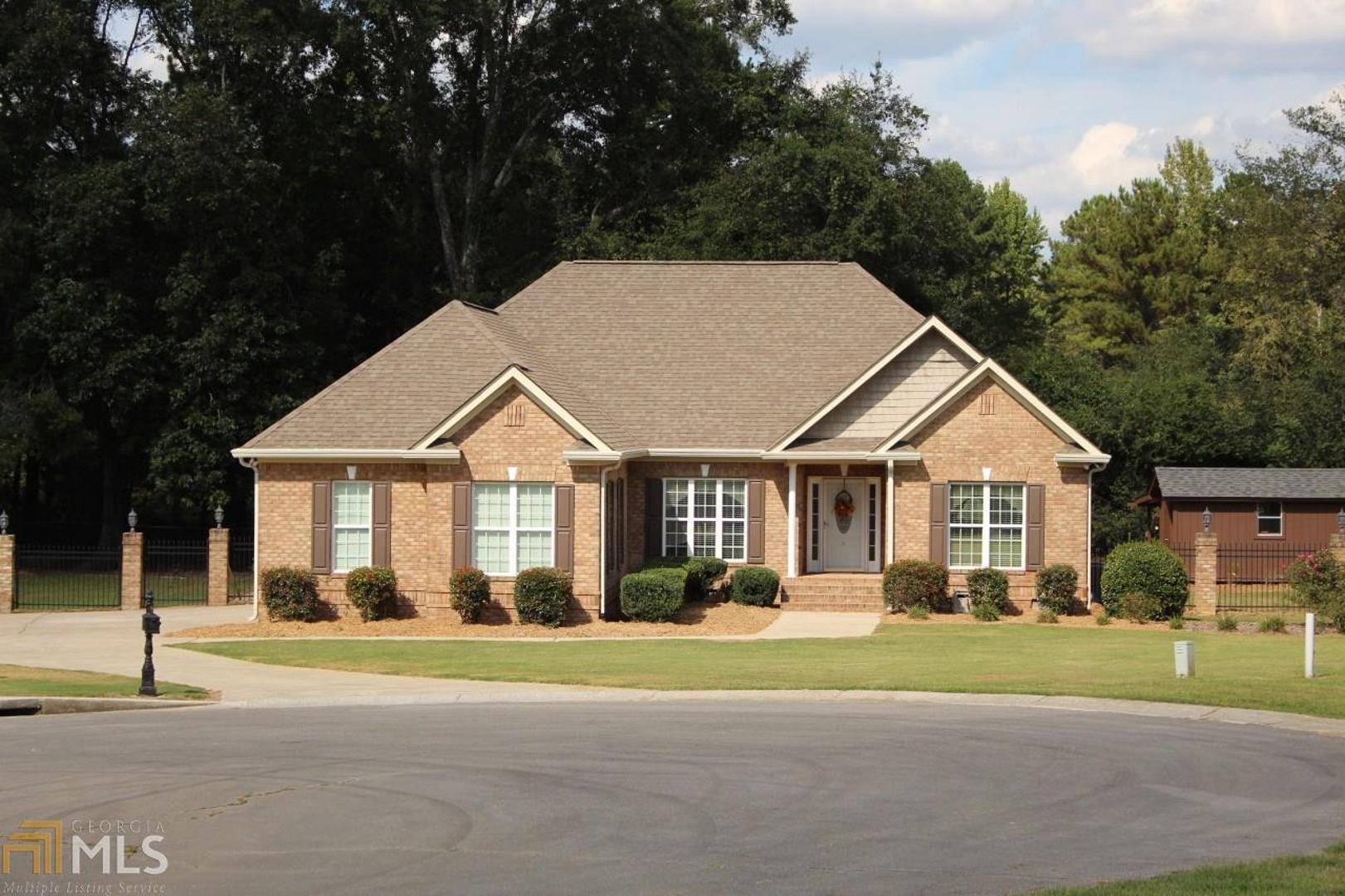 4 side Brick Single Level home in wonderful neighborhood. Just outside city limits but convenient to everything. Open floor plan, hardwood floors throughout. New propane tank in 2017 with gas logs and gas grill hookup. 10 x 16 outbuilding with shed roof attached. Built in cabinets in great room and sound system. Large deck with covered kitchen area and outdoor fireplace. Fenced back yard with lighted colums on front side. Seller is Owner/Agent.