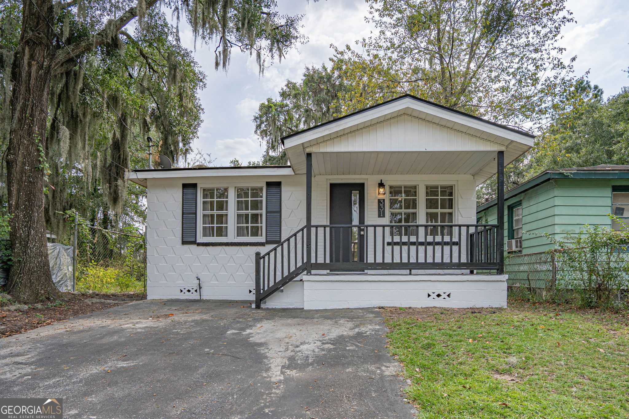 Fully-renovated mid-century modern home with stunning updates! Perfect for those seeking a simpler way of life without compromising on quality or location. This home offers solid, energy-efficient construction with decorative Shadowall blocks in front. From the welcoming porch, step into a bright, open floor plan with LVP flooring. It leads to a professionally-designed kitchen, from the custom-built, real wood shaker cabinets to the sleek retro Galanz refrigerator with matching microwave. The pass-through window ensures no one is left out of the party. Adorable bathroom features classic subway tile with shower niche, pale blue tile floor, & thoughtfully-selected details. Additional highlights include all new exterior doors, appliances & fixtures, HVAC & spray-foam insulation, lighting & electrical, & updated plumbing. The house is conveniently located near shops, restaurants, downtown Savannah, SCAD, Hunter Army Airfield, & freeway access. Call for your tour of this charming gem today!