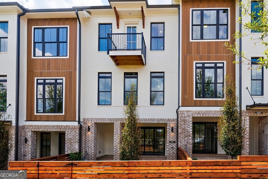 Welcome to your dream townhome where modern design meets community charm! From your front door, you'll enjoy a picturesque view of the park and easy access to the inviting outdoor community fireplace-perfect for gathering with neighbors or unwinding after a long day. Inside, this three-story home offers 3 spacious bedrooms and 2.5 bathrooms, blending style and functionality at every turn. The entry level features a bright, versatile room that opens to a private brick patio-an ideal flex space for a home office, gym, or media room. The main level is the heart of the home, with an open-concept design that flows seamlessly between the living, dining, and kitchen areas. The gourmet kitchen boasts quartz countertops, 42" cabinets with crown molding, premium GE stainless steel appliances, and a large island perfect for entertaining. Step outside to your private deck to enjoy morning coffee or evening relaxation. Upstairs, the owner's suite feels like a retreat with its spa-inspired bathroom and walk-in closet, while two additional bedrooms provide plenty of space for family or guests-one even opening to a second private deck. A two-car garage with EV charging, additional driveway parking, and guest spaces throughout the community make life easy. Best of all, this location puts you just steps away from some of the best restaurants in the city and minutes from Avalon, Downtown Alpharetta, Topgolf, and the soon-to-open Atlanta National Pickleball Club. With quick access to Hwy 400, you can get anywhere with ease. Plus, HOA-maintained landscaping and lawn care give you more time to enjoy the vibrant lifestyle this community offers.