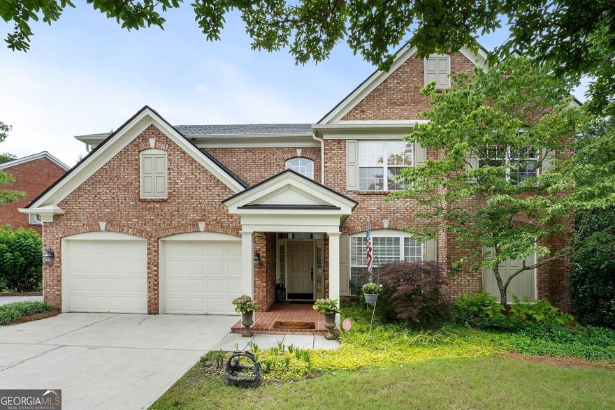 On the market for the first time, this beautifully appointed former model home occupies the most sought-after lot in Olde Vinings Registry, highlighted by a pristine, landscaped garden that creates a serene and private retreat. A comprehensive 10-year old renovation introduced a bright sunroom with vaulted ceilings, new insulation, solid wood doors, a refreshed kitchen with lovely countertops and backsplash, and a fully remodeled spa-like primary bathroom. The primary suite is conveniently located on the main floor, accompanied by a main-level laundry room that doubles as a mudroom and provides direct access to the attached 2-car garage. The heart of the home boasts a soaring two-story living room with gas fireplace and open concept kitchen perfect for entertaining. Upstairs, discover three spacious bedrooms, two full baths, a dedicated closed-door office (or 5th bedroom without a closet, and a versatile loft-perfect for a second living room.  A 3-year-old roof, newer HVAC, and HOA-maintained yard complete the low-maintenance lifestyle. Enjoy direct walking path access to your favorite restaurants, shops, grocery stores, and trails, and easy connectivity to Vinings via Paces Ferry, West Village in Smyrna, Truist Park, and I-285. Located in a quiet, brick-walled community of just 32 homes on a cul-de-sac with no through streets, this home offers privacy, elegance, and low-maintenance living with HOA-maintained yards and low Cobb County taxes. No expense has been spared in this home. Truly unlike any other in the neighborhood.