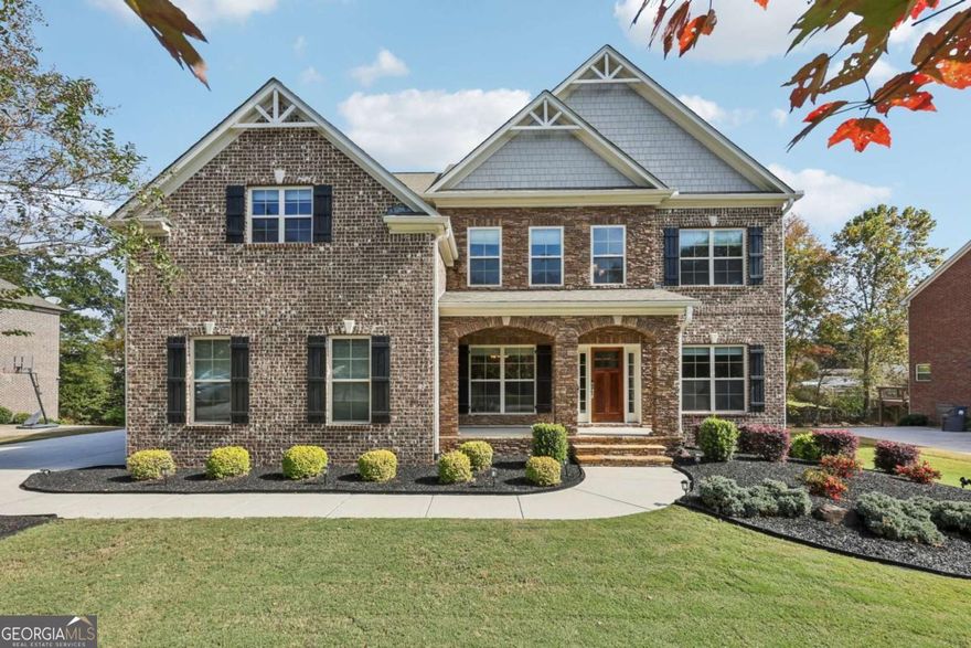 Gorgeous, move-in ready home with luxury finishes and incredible spaces! Beautiful hardwood floors welcome you inside to a formal dining room with elegant details and a private office with French doors. The 2-story living room features a wall of windows and a stunning stone fireplace. Enjoy the modern kitchen offering a large island with seating, granite countertops, stainless steel appliances, tile backsplash, walk-in pantry, butler's pantry, and sunny breakfast room. Main-level bedroom with a full bath is a great guest/MIL suite! Upstairs, retreat to the oversized primary suite featuring a spa-like bath with dual vanities, soaking tub, glass shower, and huge walk-in closet with custom built-ins. Two bedrooms share a Jack-and-Jill bath; a third has private en-suite access. Don't miss the finished daylight basement providing exceptional versatility with multiple living spaces (media room, game room, gym - you choose!) including a space with a sink for a future snack bar, plus an additional bedroom and full en-suite bath. Whole home filtration adds peace of mind. Outside, enjoy a fenced backyard backing to trees, a spacious deck for entertaining, and a covered patio. Located in a sought-after community with top-rated schools and amenities including a pool, tennis courts, and pond. Just minutes to downtown Woodstock with endless dining, shopping, and entertainment options. Book your today today!