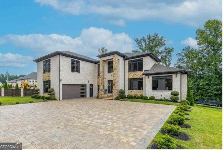 In the illustrious Camp Branch neighborhood, there lies a magnificent masterpiece just under 9,300 sq. ft. A true embodiment of luxury offering you the opportunity to build two more homes on the included adjacent 1.5 acre lots!! If that doesn't entice you then maybe a 10 car garage? Tennis court? Pool? This extraordinary estate home is situated on 3.67 acres and offers endless possibilities! Upon entering through the secure gated entryway into the beautifully paved courtyard, you're greeted by rows of emerald green trees adorning your privacy fence. This home offers a fully fenced lot with meticulous landscaping, irrigation system, multi zoned security system with cameras, a grilling area, a generator and exceptional curb appeal. The heart of the home ventures into a brightly lit family room with large European windows, leading into the gourmet kitchen where culinary fantasies come alive amidst state-of-the-art appliances and elegant finishes. This gourmet kitchen is a visual delight with glossy white frameless european cabinets, quartz countertops and custom cut backsplash. The home's expansive glazing maximizes wall space for showcasing art collections. Floating staircase and glass landing area overlooks the living area. The owner's private retreat on the main level with a spa-like bathroom features spacious dual vanity, huge soaking tub, long frameless shower and designer marble. Laundry room on both the Main AND Upper lever. Each additional room is thoughtfully designed and generously sized, each with its own bathroom. Fully Finished Basement. Game Room. Second Kitchen. Fitness Center. Networking Room. Two additional bedrooms and a very luxurious sauna. Covered rear porch and huge patio. This Camp Branch estate is not just a house, it's a narrative of elegance and luxury, a story waiting to be lived. Here, in Buford's most coveted neighborhoods, your life of luxury awaits.