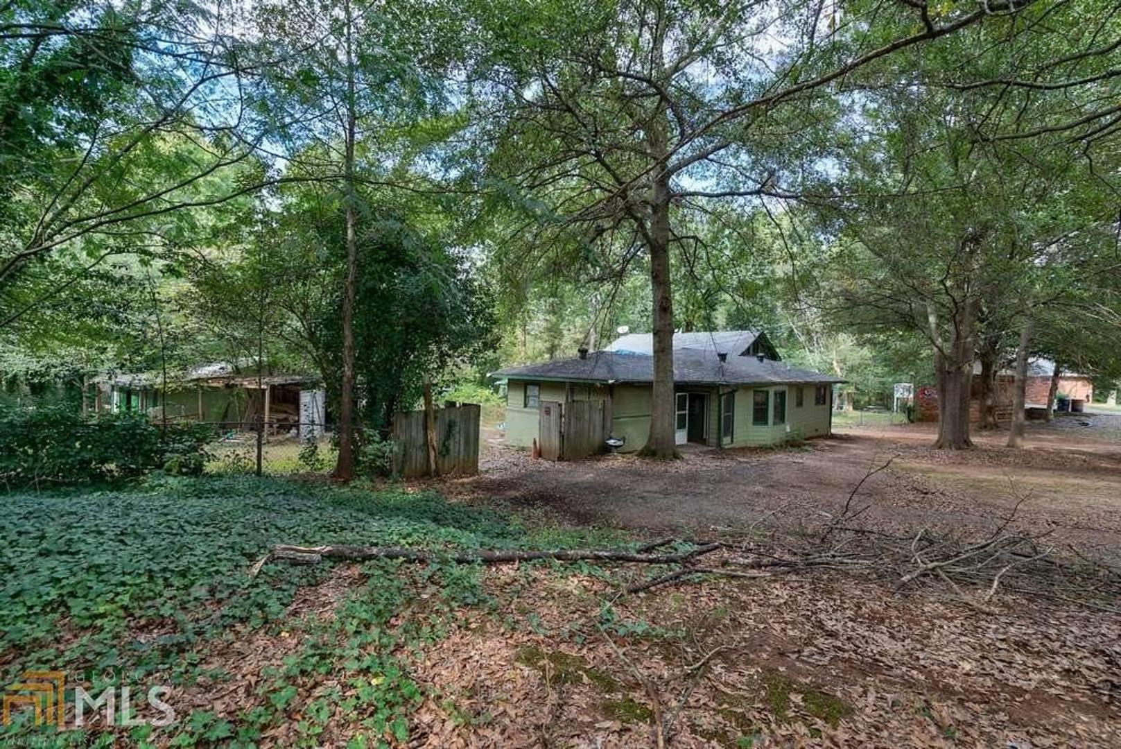 Great investment opportunity! On .5 acres convenient to I-75, shopping, parks and recreation. Can be sold with 3111 Skyview Ln. Add your finishing touches to make small 1-bd/1-ba bungalow, or build new. Close to Shaw Park, Town Center at Cobb, and Kennesaw University. Great level wooded lot. Purchase with 3111 Skyview Ln, adjacent property. Both properties form a triangle that goes all the way to the corner of Skyview and Brackett Rd,together totalling approximately 1.4 acres. New construction right behind this property selling for almost $300,000.