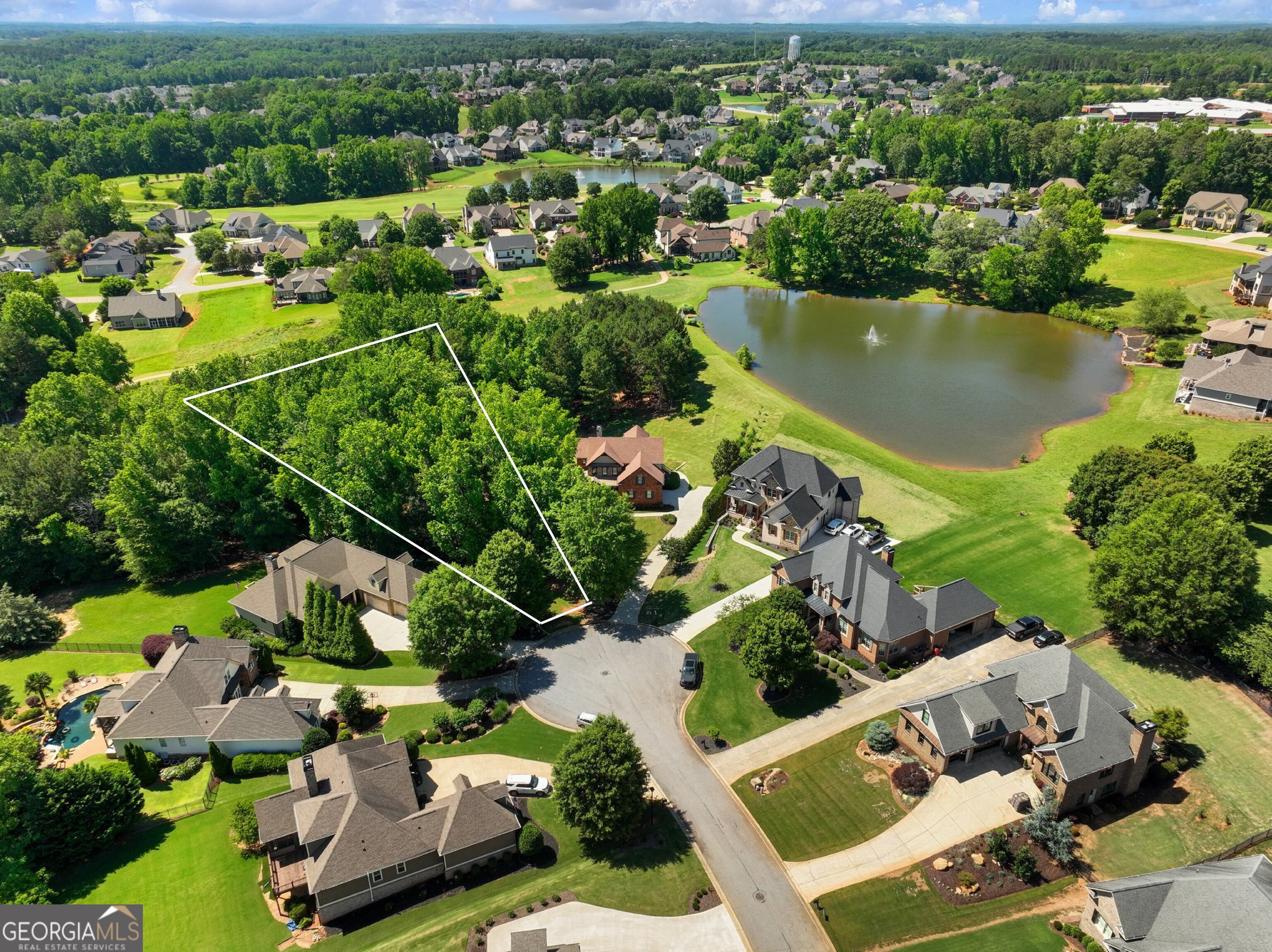A Rare Opportunity in Traditions of Braselton! Build your private retreat surrounded by nature. Tucked into a quiet cul-de-sac and backing to Hole 6 of the private Traditions golf course, this .56-acre wooded lot offers a unique blend of privacy, natural beauty, and prime location. Just steps from Baker Pond, the setting feels like a private nature preserve complete with mature hardwoods, serene views, and even a natural spring head tucked into the landscape. This property is buildable and ready for development. A county-approved variance allows for building closer to the spring head than typically permitted, giving you the flexibility to design your custom home while preserving the surrounding beauty. Whether you're looking to build a quiet retreat or expand your footprint from the neighboring property available for purchase (70 Baker Pond Ct), this lot offers exceptional potential in one of Jefferson's most sought-after communities. Enjoy all the lifestyle perks of Traditions of Braselton, including a private golf course, on-site restaurant (Twenty7), resort-style pool, tennis and pickleball courts, miles of walking trails, and private golf cart access to Gum Springs Elementary School, West Jackson Middle and Gum Springs Park. One of the few remaining lots of this size and setting, don't miss the chance to create your dream in the heart of Traditions.