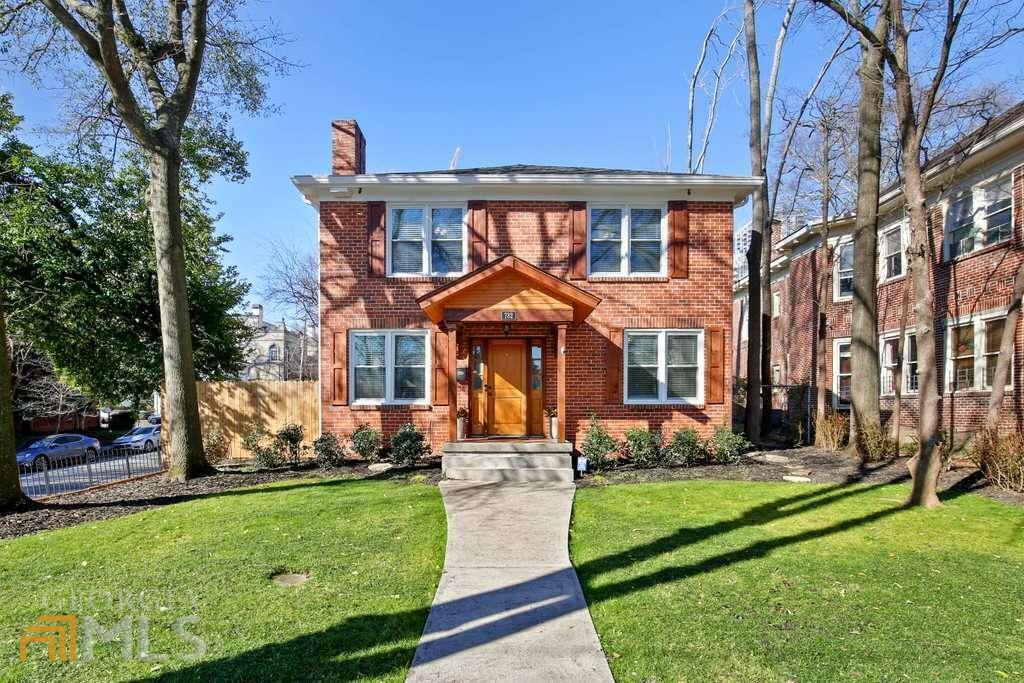 Welcome home to this fully renovated 1930 brick gem with 2-car garage, an in-law studio, and total 4 beds/3.5 baths, on the best street in the heart of Midtown, sitting on a large corner lot, within walking distance to Piedmont Park, Fox Theatre, GA Tech, Emory Hospital, new Google building. Restaurants, bars and everything that Midtown has to offer. High ceilings with crown molding and original hardwood floors throughout, the inviting, natural light-filled living room with fireplace opens to a study with built-in bookshelves on three walls. An open floor plan in the spacious kitchen and dining room that boasts a large island with granite countertop, ample work space and stainless-steel appliances. A new wifi-enabled gas range oven and a new 36-inch vanity have been installed (see photos). Custom-built cabinetry with wine rack and tons of storage, a walk-in pantry, a bench by the back door for your shoes and hanging your bags and jackets. A set of French doors takes you to a comfortable sunroom with exposed bricks and a stunning Midtown skyline view. A large deck, great for entertaining, overlooks a private fenced and landscaped backyard that your friends and family are sure to be impressed by. Great for a dog. A red brick pathway leads you to an oversized 2-car garage with work station and tons of storage space which is rare for in-town properties. Above the garage is an in-law studio (approx. 365 SF in addition to 3136 SF in main dwelling) with full bath and kitchenette and separate entrance for your guest or potential rental income. The ensuite master bedroom features 2 walk-in closets, sizable bathroom with double vanity and granite countertop, a cast iron bathtub and a large all-glass shower with double shower-head. One of the 2 additional large bedrooms also has a walk-in closet. A fresh coat of paint inside out. The large private backyard has room for a swimming pool if so desired. Four-sided brick requires no maintenance. Unfinished partial basement provides additional storage space or to build your own wine cellar. Roof was replaced in 2016. All windows are of energy-efficient double pane with security devices that keeps the 2-zone heat/cool air in and noise out. This home has been consistently rated the top energy saver by the utility company compared to homes of similar size in the area. Electric panel with large capacity was professionally installed in 2020, with a whole-house surge protector that is warranted by the manufacturer for your peace of mind. In a fantastic quiet, walkable, and family friendly neighborhood, this loving home is move-in ready, waiting for the new owners to love, to live a high life in the exciting heart of everything.