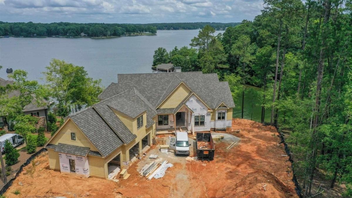 ''BRAND NEW STUNNING LAKE FRONT CONSTRUCTION, INCREDIBLE SUNSET VIEWS IN THE HORSESHOE BEND SECTION OF REYNOLDS LAKE OCONEE" Quality abounds in this 6,800+ sq ft lake home by luxury home builder Luxe Construction featuring 6 bedrooms, 6 baths, 2 half baths, infinity pool, home theater, elevator. Ideally located on the main part of the lake- boat across to Great Waters for golf or dinner, short boating distance to Richland Pointe, Ritz Carlton, Lake Club. Easy access to extensive Reynolds Lake Oconee walking trail. Front row sunset views every evening from your porch, dock and infinity pool! The fantastic elevation gives you magnificent views of the lake from the house! Details include vaulted ceiling, 16" sliding doors with custom transom, extra large wood burning fireplace with floor to ceiling plaster and concrete surround, master suite on main with shiplap accents, balcony access, vaulted ceilings, oversized his and hers custom closet, generously sized walk-in closets with Brizzo Sensori high flow shower system. Second main level suite features shiplap accent wall, walk-in shower and closet. The expansive luxury Chef's kitchen features Wolf 48' dual fuel professional series range, 42" Sub Zero French door refrigerator, Wolf microwave drawer, Wolf coffee station, Quartzite countertops with 36' single bowl farm sink and Brizzo bridge faucet, custom cabinetry. High shiplap wainscoting in the mud room. Terrace level features guest suites, 12' ceiling, private baths, white oak floors, custom bar with subzero beverage , leathered granite bar top, billiard room, cofered ceilings. There is a pebble finish shortcrete pool with automatic cover and infinity edge, max boat dock with composite decking, screened dining porch. The list goes on and no details overlooked in this quality lakefront home. Membership is available.