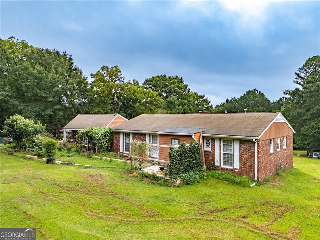 Charming Mini-Farm Opportunity Just 6 Miles from ATL Airport! Welcome to 6250 Feldwood - a rare 3-acre property offering space, privacy, and endless potentials in the growing College Park area! Nestled just minutes from Hartsfield-Jackson International Airport, this unique property features a spacious 5 bedroom, 5 bath and 2 kitchens home (quasi duplex), set back from the road, surrounded by open land and mature trees -ideal for homesteading, gardening, or creating your own private retreat. Inside, you will find a bright and functional layout with hardwood floors, large windows, and a cozy family room. The partially updated kitchen includes ample cabinetry and flows into a separate dining area. The primary suite includes an ensuite bath and generous closet space. Outside, enjoy the expansive backyard, perfect for small livestock, recreational use, or even building an additional structure (pending permits). Whether you are looking for a primary residence with land, an investment opportunity, or a peaceful property close to the city, this one checks all the boxes. No HOA. Easy access to I-285, downtown Atlanta, and major employers. Bring your vision and explore the opportunities!