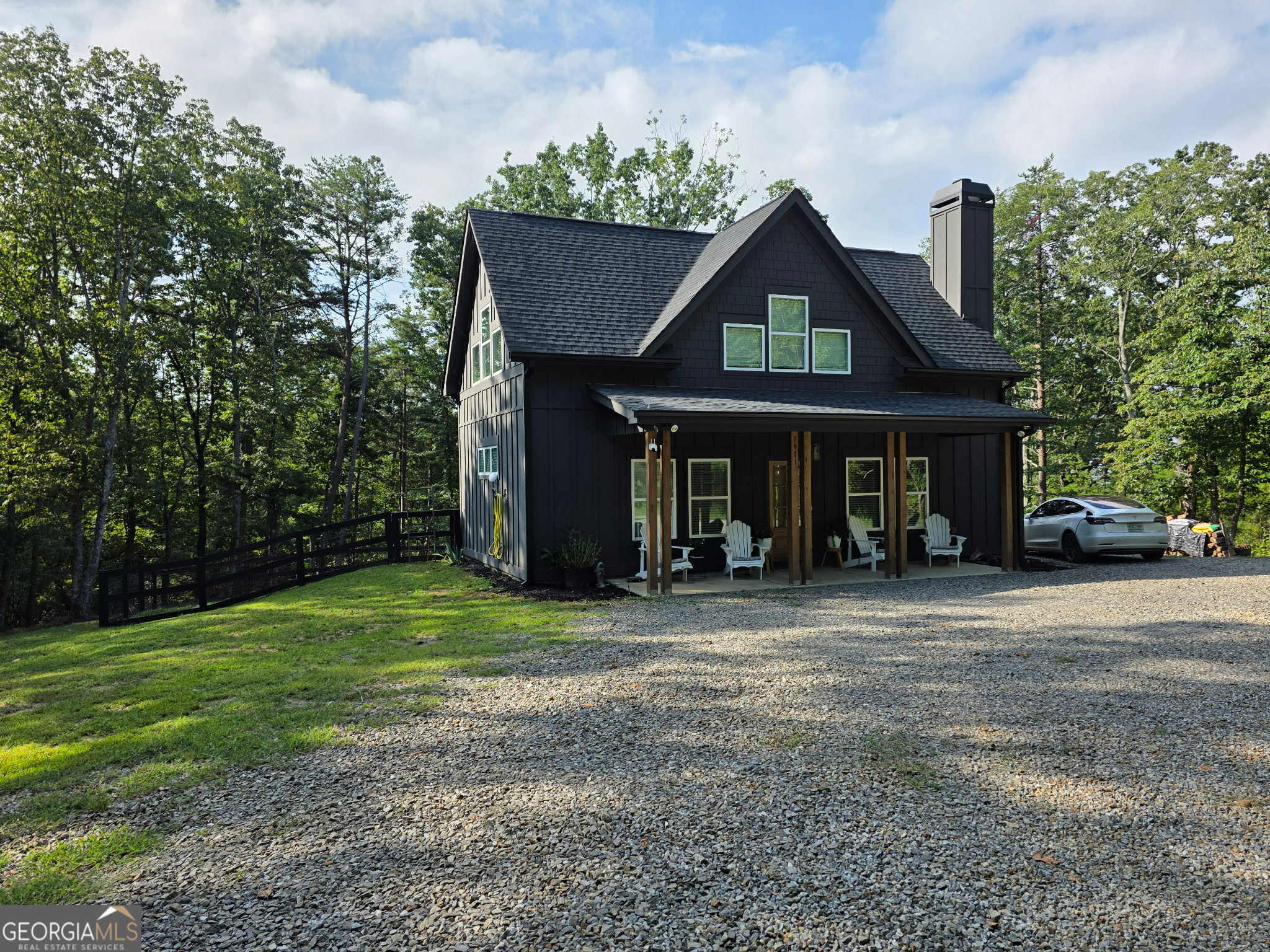 Escape to the mountains in this modern chalet-style cabin in the sought-after Talking Rock Creek Resort. This 3-bedroom, 2-bath home offers stunning long-range mountain views and a perfect blend of rustic charm and contemporary finishes. Enjoy multiple outdoor living spaces, including a covered front porch, a covered back patio, and an additional deck-ideal for soaking in the scenery. Inside, you'll find custom finishes throughout, creating a warm and inviting atmosphere. The fenced-in backyard is perfect for pets or play, and the outbuilding provides extra storage or workshop space. Located in a gated community with great amenities, this property offers both comfort and adventure in one beautiful package! This would be perfect for anyone downsizing, first time homebuyer or looking for a weekend getaway that you can use as a short term rental and make a great profit!