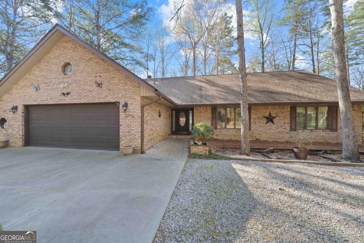 CHARMING LAKEFRONT BRICK RANCH PRIVATELY NESTLED AMONG HARDWOOD TREES ON A LEVEL LAKEFRONT LOT WITH 234FT OF BEAUTIFUL LAKE OCONEE SHORELINE. DESIGNED TO BRING THE OUTSIDE IN WITH LOADS OF WINDOWS. LOTS OF FAMILY SPACE, A LIVING ROOM WITH BUILT IN'S, WOODSTOVE AND BANKS OF WINDOWS. A DEN WITH FIREPLACE OPENS TO A FABULOUS LAKESIDE SUNROOM YOU WON'T WANT TO LEAVE. THE KITCHEN HAS LOADS OF CABINETS, WINDOWS WITH A VIEW AND A DINING AREA THAT OVERLOOKS A NICE DECK AND A PRETTY, LEVEL WALK TO THE DOCK. THE MAIN FLOOR HAS 2 LARGE BEDROOMS, 2 BATHS, A LAUNDRY WITH BUILT IN DESK AREA. THE UPPER FLOOR HAS TONS OF POSSIBILITIES, A STUDIO, OFFICE OR EXTRA BEDROOM. WITH THE OPTION OF ADDING A 3RD BATH, COULD BE A WONDERFUL SUIT. THE BASEMENT PROVIDES THE PERFECT SHOP SPACE. A 2 CAR GARAGE AND AN ADDITIONAL BOAT/RV CARPORT PROVIDE COVER FOR ALL THE LAKE TOYS. THIS PROPERTY IS TRULY AMAZING, THE PERFECT SPOT FOR MAKING MEMORIES.....