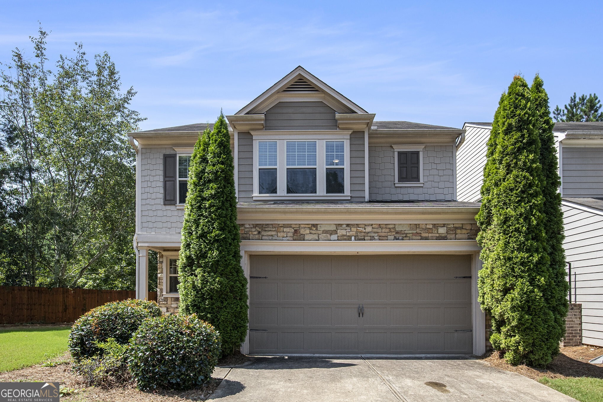 Tucked away at the end of a quiet cul-de-sac in a desirable Alpharetta neighborhood, this beautifully maintained home offers privacy, curb appeal, and an ideal floorplan. With 3 bedrooms, 2.5 baths, and 2,166 square feet of living space, you'll love the open layout, freshly painted interior, and move-in-ready condition. The main level features hardwood floors, an open dining room with picture frame molding, a bright office/study, and a spacious family room with a cozy fireplace. The kitchen is equipped with granite countertops, stainless steel appliances, a breakfast bar, and views into the family room perfect for entertaining. Upstairs, the vaulted owner's suite boasts a spa-like bath with double vanities, tiled floors, a separate garden tub and shower, and a generous walk-in closet. Two additional vaulted bedrooms, an upstairs laundry room, and a large bonus area complete the second floor. Enjoy the peaceful, fenced backyard and the charm of the home's gorgeous exterior featuring stacked stone and cedar shake accents. All in an unbeatable location close to top-rated schools, parks, and shopping. This is the one you've been waiting for!