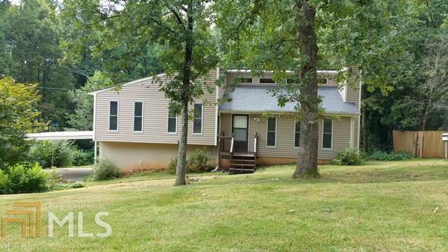 "Back on the Market"! No fault of the sellers-buyer financing fell through. Cedar Exterior w/ Newer Vinyl Siding Covering. Well Insulated Contemporary Home. Freshly Painted Interior/New Vinyl Windows/French Doors & Hardwood Flooring in Living/Dining & Kitchen. Open Concept Floor Plan - Cathedral Ceiling w/ Rock Fireplace in Family Room, Real Wood Cabinetry in Kitchen, All Appliances will remain. Breakfast Bar. New Toilets, Tub & Shower Fixtures. Large Deck Overlooking Gorgeous Backyard w/Beautiful Flowering Trees & Shrubs. Storage Building Remains - Finished Room in Basement Would be a Great Office or Workout Room. Great Workshop area w/Boat door. 2 Car Carport. Great Location to Shopping and I-20. Do not delay!