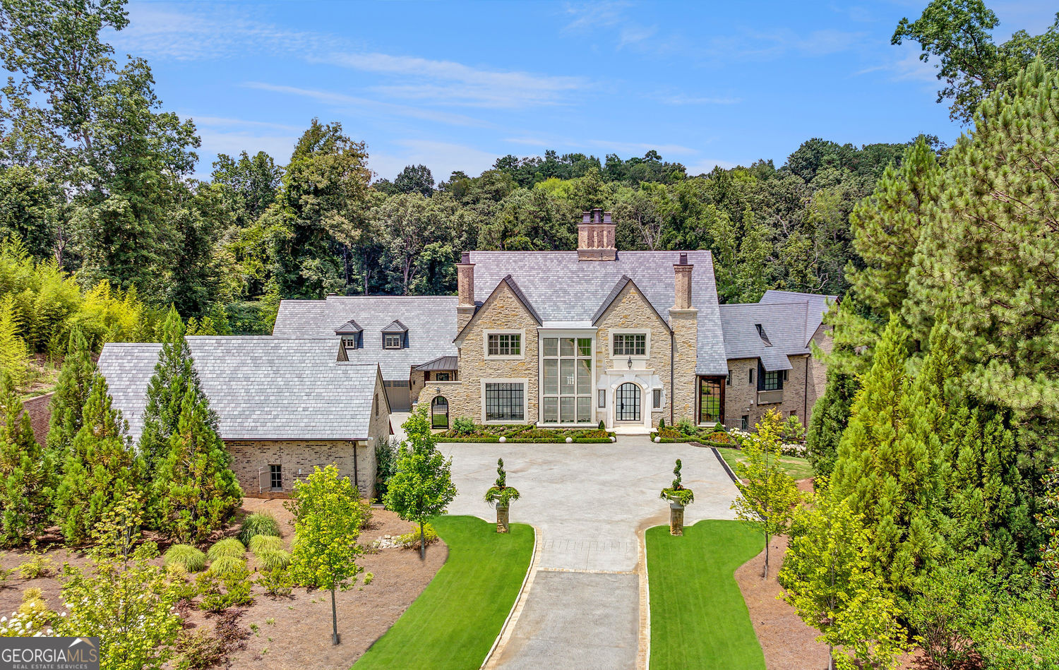 This estate offers an unparalleled blend of security, recreation, and refined living in the desired City of Sandy Springs. Fully fenced 6.58 acres with a perimeter of mature maple trees, the grounds ensure total seclusion. A state-of-the-art Optex LiDAR outdoor intrusion detection system throughout the entire grounds, Savant home automation, Cellgate controller with remote access control, interior/exterior surveillance cameras, and upgraded fiber connectivity to the property to elevate both safety and convenience. Built for entertaining and wellness, enjoy a private lake with fountain and dock, upper-level turfed sports lawn for soccer or football, a separate sodded court for pickleball or basketball, nature trails for walking or motor biking, and indoor amenities including a built-out area for a Full Swing golf simulator, lap pool, basketball court, home gym, home theater with HD projector and screen, and dry sauna. Two private guest homes are seamlessly integrated into the estate (bed/bath included in total), and an elevator services every floor from the attic to the basement in the main home. Dual Kohler water-cooled generators provide peace of mind. The current owner has meticulously enhanced the property beyond its original build, resolving every nuance of new construction on this scale. Homes of this caliber are rare to market, and even rarer in execution. **Please note that all Buyers are to be pre-screened, along with their finances, prior to any showing appointments being scheduled. DO NOT TRESPASS ON THE PROPERTY.