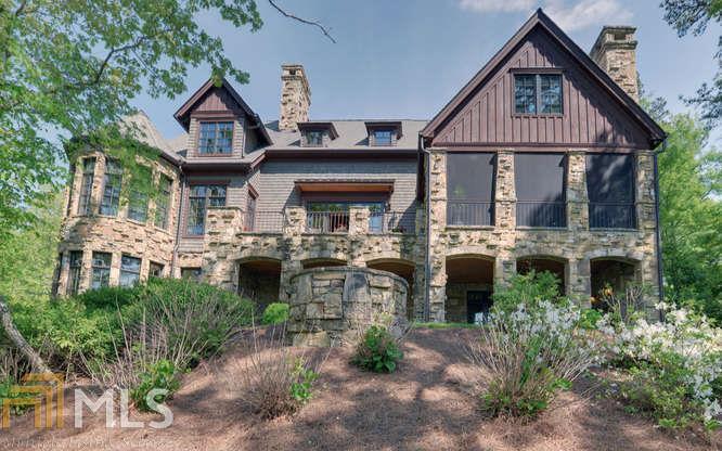 The BEEHIVE on Burton, a 6 BR 6.5 BA masterpiece, stands on a point lot overlooking the main lake. Built by Dale Burton this private retreat offers luxury, style and quality. Living areas feature five masonry fireplaces, a fire pit and spectacular mountain sunset views. The main level features an open floor plan, vaulted great room, hardwood floors, chef s kitchen, and master suite with luxurious bath and lake-front lounge. Enjoy outdoor living on the screened porch with fireplace or open porch under the stars. Upper level features a kid s suite at one end, and a bedroom with fireplace and bath at the other. Lake level has a huge living area, second kitchen, three bedrooms, and covered porch. A few steps away is the two-slip boathouse with upper party deck.