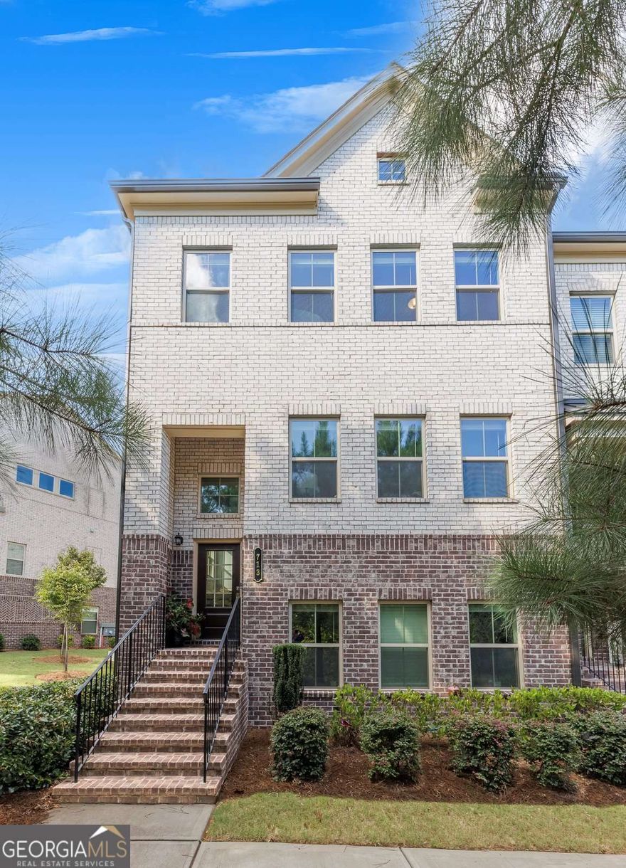 Welcome to this beautiful townhouse in Haddonstone, a golf cart-friendly community that's walkable to the vibrant heart of Downtown Woodstock. Featuring one of the largest floor plans in the neighborhood, this home combines generous space with comfort, style, and convenience. Its thoughtful design and prime location make it a truly special place to call home. The spacious main level showcases an open-concept layout with a family room featuring a cozy fireplace framed by custom built-ins, seamlessly flowing into the dining area and a stunning kitchen. The kitchen boasts a large center island with seating, white cabinetry, and stone countertops. Just beyond, a bright and airy breakfast area offers flexibility as an additional dining space, home office, or reading nook. A keeping room off the kitchen provides the perfect spot to relax and offers direct access to the covered deck-ideal for enjoying morning coffee or dining al fresco. A convenient guest powder room completes the main level. Upstairs, the oversized primary suite impresses with a tray ceiling, sitting area, and walk-in closet. The ensuite bath features dual vanities and a glass-enclosed walk-in shower, creating a spa-like retreat. Two additional generously sized bedrooms share a hall bath, and a laundry room is ideally located on this level for everyday ease. The lower level includes a two-car rear-entry garage with a practical drop zone, as well as a light-filled bedroom and full bath, perfect for guests seeking privacy. This end-unit home is also situated next to a green space, ideal for play or walking your dog, and in close proximity to guest parking, making it especially convenient for visitors. Living in Haddonstone means enjoying a low-maintenance lifestyle with exterior upkeep and landscaping included. Neighborhood amenities include a sparkling pool and clubhouse, while the community's prime location offers easy access to I-575 and the express lane for smooth commuting. Just minutes away, Downtown Woodstock awaits with its charming shops, restaurants, entertainment, and access to the expansive Greenprints Trail system. Discover why this thriving North Georgia town is one of the region's most sought-after places to call home.