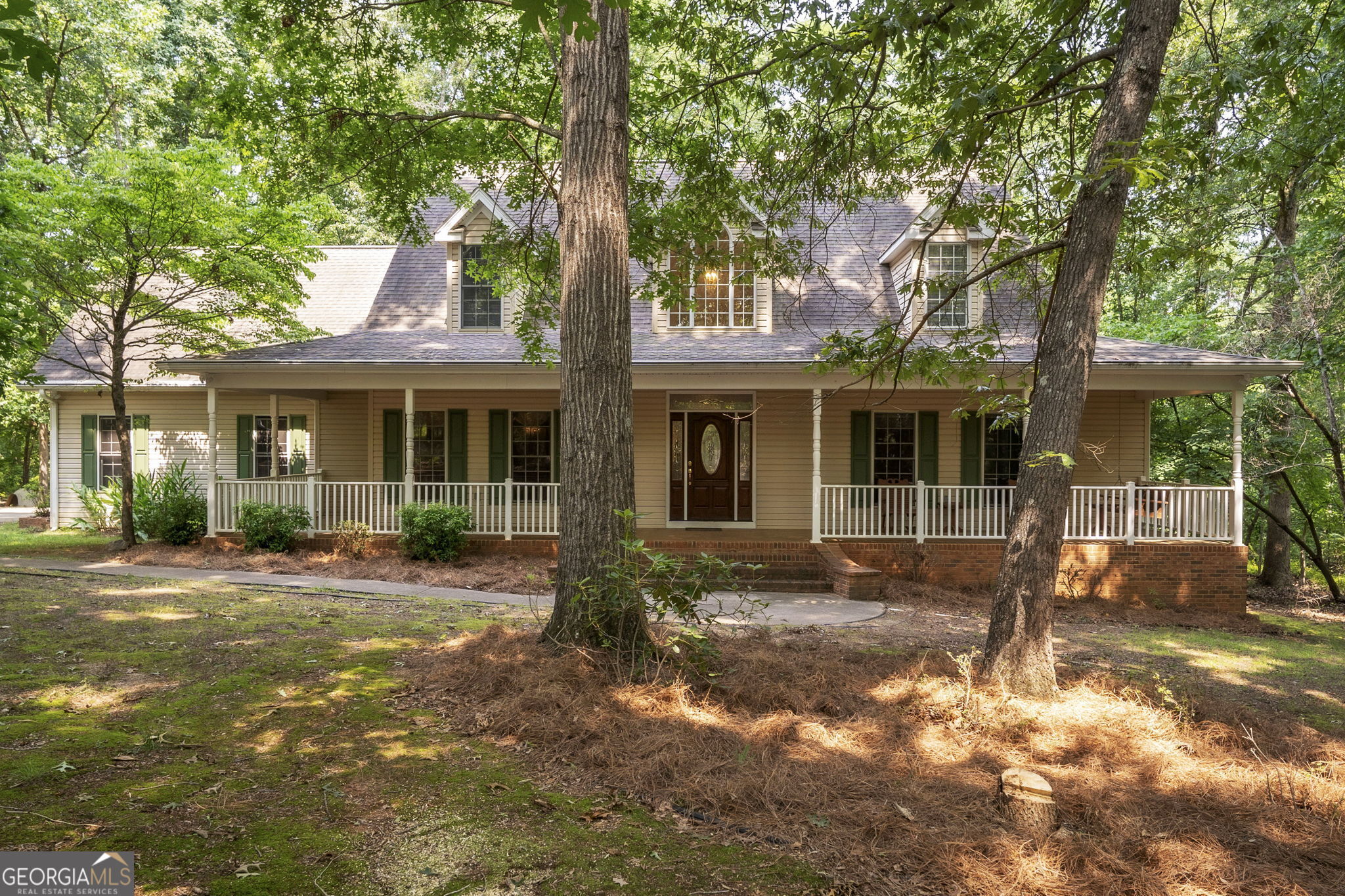 Your Piece of Paradise on Lake Hartwell Awaits! Welcome to your dream retreat nestled on a serene wooded lot just steps from Lake Hartwell. As you drive down the private, tree-lined driveway, you'll discover a stunning Southern Cape Cod Craftsman home tucked into a peaceful clearing. A spacious covered front porch-with elegant curved brick steps-invites you to sit back and enjoy nature's show, from deer grazing to foxes at play. Step inside and experience the exceptional craftsmanship and attention to detail throughout. The grand living room features vaulted ceilings, large arched windows that flood the space with natural light, beautiful hardwood floors and a striking stone fireplace. French doors open into a cozy home office, while the formal dining room showcases classic craftsman-style trim. The heart of the home is the custom kitchen, complete with a center island, premium cabinetry, and thoughtful design elements perfect for both cooking and entertaining. An arched doorway leads to a bright and airy sunroom with sky lights, ideal for relaxing with a book or morning coffee. The oversized primary suite offers a peaceful retreat with its own private deck, perfect for enjoying quiet mornings or evening breezes. Upstairs, there are 2 other bedrooms with a hallway open to the living room. The bonus room above the garage offers flexible space-ideal for a game room, home gym, craft room, or second office. The home also boasts abundant storage throughout, including a two-car garage with a separate workshop area. Step out back and follow a private path down to the lakefront beach, where you can fish, swim, kayak, or simply relax and watch the water. You can even beach your boat right there! With three public boat ramps nearby, lake life couldn't be more convenient. Don't miss sunsets from your back deck during warm summer evenings. This is more than a home-it's a lifestyle. Come see this Lake Hartwell oasis and make it yours! OPEN HOUSE Sunday August 24 from 11am til 1pm