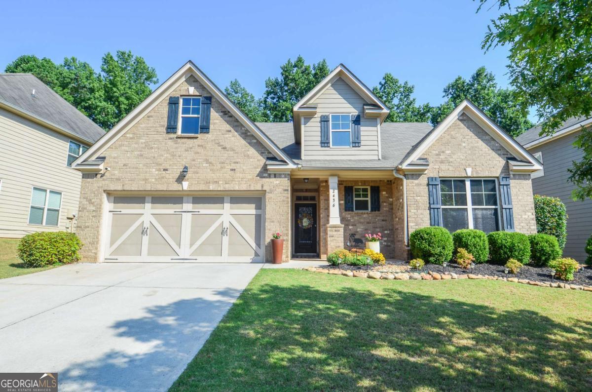 Welcome to this spacious and thoughtfully designed 4-bedroom, 3-bath home in a sought-after planned community with a neighborhood swimming pool, located in the desirable Seckinger High School Cluster. Built in 2015, this home combines modern comfort with classic charm and is ideally located near the Mall of Georgia, Bogan Park, top-rated schools, dining, youth recreation facilities, and major freeways. The main level features 3 bedrooms and 2 full baths, including a private ensuite primary suite, while the second floor offers a 4th bedroom, full bath, and a versatile loft space perfect for a home office, playroom, or guest retreat. Enjoy effortless entertaining in the large open-concept kitchen, complete with white cabinetry, granite countertops, stainless steel appliances, pantry, and a generous island overlooking the dining and living areas. The dining space is enhanced by coffered ceilings and wainscoting, while the living room impresses with soaring two-story ceilings, abundant natural light, and a gas fireplace that turns on and off with the flip of a switch. The fenced and landscaped backyard is a peaceful retreat, featuring lush hydrangeas and hostas, along with a covered patio-perfect for outdoor relaxation. Additional highlights include wood flooring in the main living areas, a 2-car garage, and an HVAC system equipped with an air filtration device for added comfort. This move-in ready home checks all the boxes-style, location, layout, and community amenities. Don't miss your chance to make it yours!