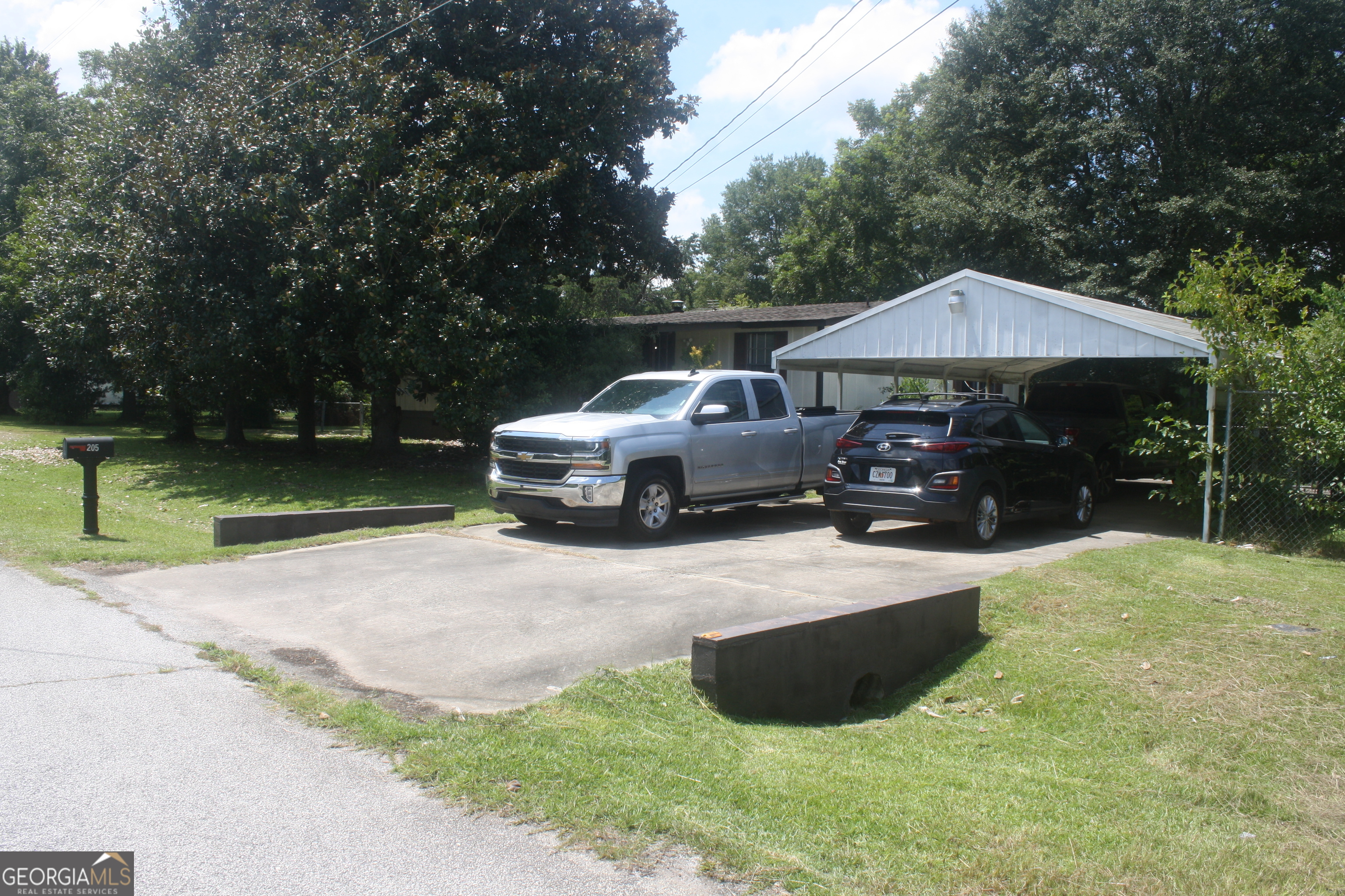 You won't find a deal like this anywhere in Houston County! This well established, 3 bedroom, 2 bath modular home comes with an adjacent lot deeded separately (.34 acres) providing space to expand or invest. This private retreat is fully fenced with 4 storage sheds, one being a small drive-in garage with a concrete block floor. It will certainly provide plenty of storage or workshop enthusiast. The wood fireplace is wood burning now but is stubbed out for gas if you desire to change it later. Apply your own special touch with a fresh coat of paint and the home will shine like new. Currently, the personal property inside is being removed and the interior is being cleaned. Sold "AS-IS"!