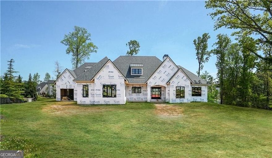 Stunning Ranch plan with finished basement, walk-out to pool, gorgeous views of the lake and golf course.  Located on 3/4 acre at the end of a cul-de-sac, this beautiful white brick and white stone house is amazing.  The entry Foyer opens to a beautiful open stairway and private home office.  The spacious Great Room includes a fireplace and opens out to a fabulous covered back veranda with outdoor bar/grill area, fireplace, seating and dining space, and opens out to beautiful private pool.  The Great Room is also open to a spacious Dining Area as well as an incredible kitchen featuring large island, breakfast bar, top-of-the line appliances, large refrigerator-freezer-wine cooler, spacious walk-in dry pantry, and spacious scullery kitchen with built-in coffee maker, additional oven, open shelves, wet bar area, and plenty of counter and cabinet space.  The Main Level Owners Suite is wonderfully private and includes a private owners porch that looks out over the lake and golf course, private morning bar, luxurious owners bathroom with double vanities, soaking tub, and spa shower, and enormous walk-in master closet.  Also located on the MAIN level are two additional spacious bedroom suites, each with private bathroom and walk-in closets.  Large Laundry Room and back Foyer with mud area complete the main level.  Down the open staircase is a finished terrace level complete with fireside Family Room, Billiard Room, card room, Theater Room, relaxing, sun-filled sitting area, two more bedroom suites - each with private bathroom and walk-in closet, enormous unfinished area for storage, and doors to covered patio which overlooks the lake and golf course.  Three-vehicle garage plus space for golf cart storage.  Wonderful flat area around saltwater pool and hot tub, and private full pool bath.  Large yard.  Beautifully appointed.