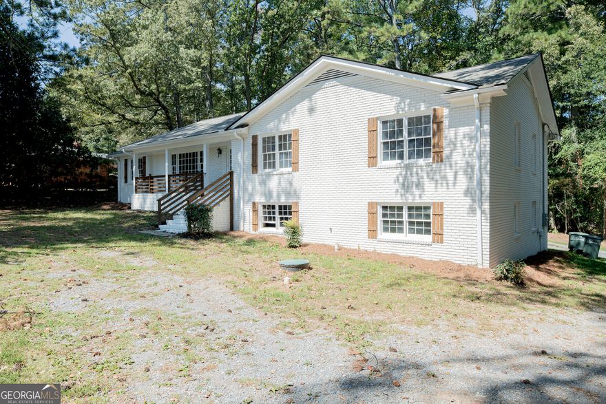 Back on Market!  No Fault of the Seller! Modern Marietta Retreat Near the Square Don't miss your chance to own this modern Marietta retreat, a fully renovated 4-sided brick ranch on nearly 0.8 acres, perfectly located just minutes from Marietta Square and Kennesaw Mountain National Battlefield Park, where miles of scenic trails and breathtaking views await.  Inside, you'll find refinished hardwood floors, new cabinets, quartz countertops, and stainless steel appliances. The spacious kitchen opens to a bright dining area and sun-filled living room, creating an inviting flow for everyday living and entertaining.  The partially finished basement adds flexibility with a bedroom and full bath, ideal for guests, a home office, or an in-law suite. Outside, enjoy a large private carport, back patio for entertaining, and a peaceful setting surrounded by mature trees, including a beautiful grand magnolia. Major updates include a new roof, HVAC, electrical system, and water heater all the big-ticket items have been taken care of. The septic tank was recently pumped, and public sewer is available at the street for future connection. With no HOA and a long private driveway, you'll enjoy both privacy and freedom. Live close to shops, dining, trails, and historic landmarks, this is Marietta living at its best!