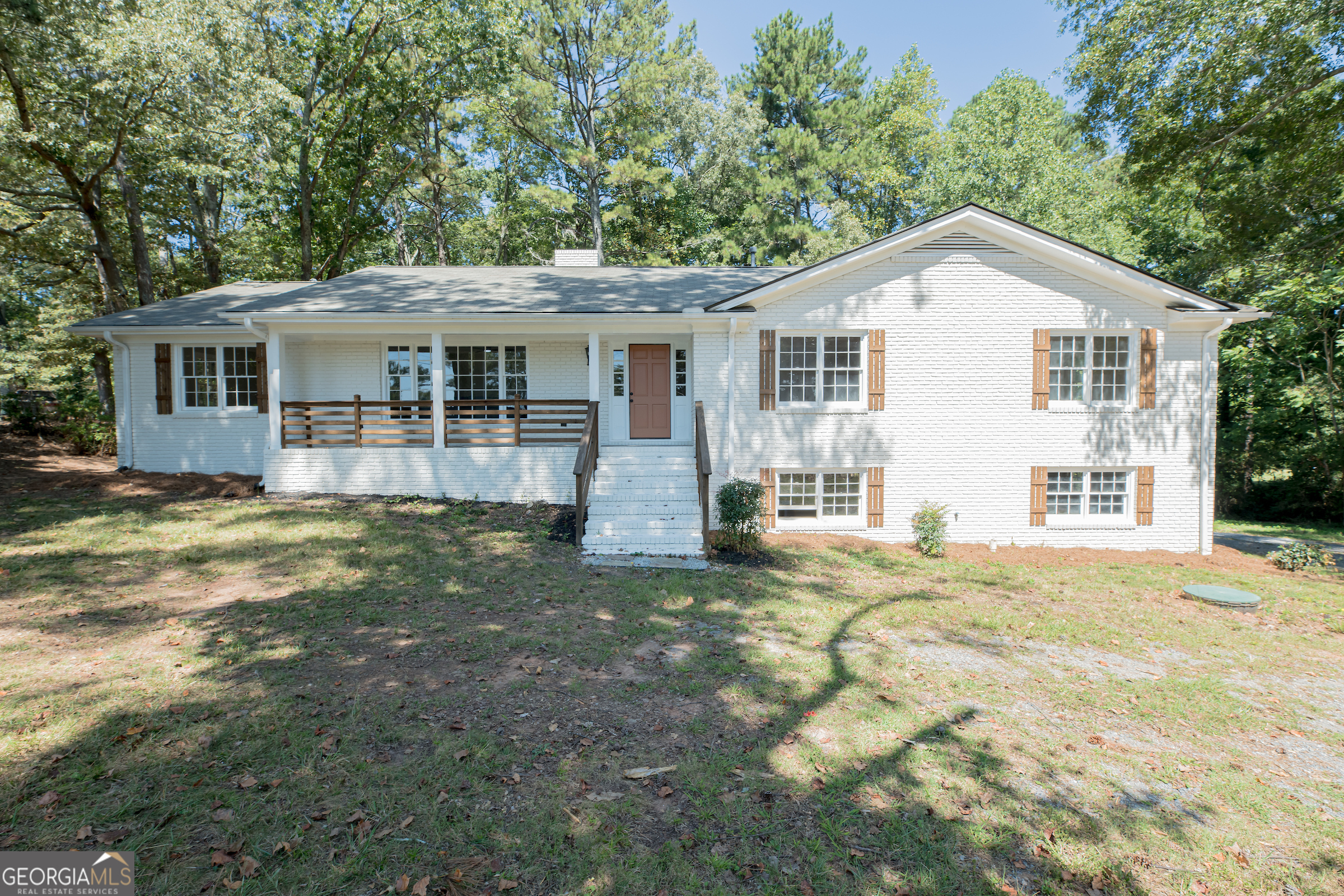 Welcome to your charming Marietta retreat! This fully renovated four-sided brick Ranch on 0.8 acres is just minutes from historic Marietta Square, shopping, dining, and major highways. Step inside to a modern oasis with new appliances, cabinets, and refinished hardwoods. The all-new-electric HVAC system and water heater ensure efficiency. The kitchen, with granite countertops, opens to a spacious dining room. Enjoy natural light in the oversized living room and find comfort in the renovated bathrooms with tile floors and new vanities. The home sits back from the street, surrounded by mature trees and a huge magnolia tree for added privacy. The large driveway and no HOA provide convenience. The full partially finished basement features a bedroom with a fireplace, and a full bathroom. Recent upgrades include a new electrical panel, meter, and roof. With the home on septic (recently pumped) and sewer available in the street, practicality meets luxury. Don't miss this opportunity to own a beautiful home near Marietta Square. Contact us for a tour today!