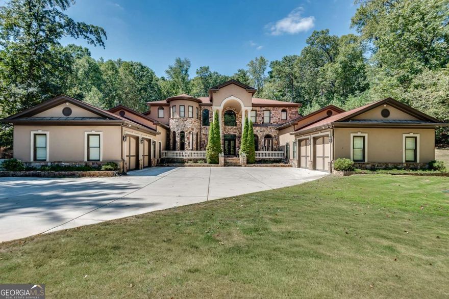 Stunning estate home on an acre in a small, luxury home community that's directly across from Kennesaw Mountain! This beauty is a true bargain, given all it has to offer. Travel the tree lined driveway to the security gate, before entering the courtyard, which is flanked by two, 2 car garages and parking spaces for two additional cars. Cross over the expansive front porch and enter through the wrought iron doorway into the two story foyer with its gorgeous, crystal chandelier. The great room, with its soaring, cathedral ceiling and wall of windows opens in front of you, offering a second chandelier, a fireplace and a view of the backyard pool, spa and patio. To your left is a full bar with seating at the stone countertop, custom shelving, an icemaker and a mini refrigerator, and is adjacent to a half bath. The bar looks out to the formal dining area, which rests in an alcove of curved, floor to ceiling windows. Beyond the bar and dining area is the expansive kitchen and keeping room. The kitchen includes tons of cabinetry and granite countertops, a huge island with lots of seating and a built in cooktop. The double ovens and double microwaves are a convenient way to hold dinner parties and holiday gatherings. The walk in pantry includes plenty of built in storage. The kitchen opens to the massive keeping room, with its floor to ceiling stone fireplace, wood plank ceiling, and patio access. The breakfast nook completes this lovely, family gathering space. Exit the kitchen and walk the hall down to the roomy bedroom and ensuite bath, perfect for visting guests or family members. Beyond this large living space is an adorable "pet palace", the laundry room with storage and counter space and the first two car garage. Cross to the other wing of the main level, passing a half bath and stately office, with wall to wall wood paneling. Continue down the hallway to a bonus room, perfect for a rec space or TV room, and the master beyond. The owner's suite is a true oasis and respite from long, busy days. The fireplace and sitting room allow you to spread out and realy relax. The ensuite master bath is just incredible. There is a second, built in laundry, two water closets, separate vanities with storage, a huge, soaking tub, double shower and a to die for master closet. This wing also offers access to the second, two car garage. Make your way back to the main living area and ascend the graceful, curved staircase to the upper level. On either side of the catwalk are two sets of bedrooms and two full baths. More space and function await below the main level. The basement is massive and includes a kitchen, two and a half baths, two bedrooms and several bonus rooms that are ideal for fitness, theater or play areas. The basement also offers access to the side yard and two stairways back to the main level. The pool and spa in the backyard is a prime spot for relaxation and fun on those hot summer days. The property itself sets on a full, tree surrounded acre and has the feel of a luxurious retreat. The location is perfect, with the Kennesaw Mountain recreation area and the shopping, dining and entertainment of both Kennesaw and Marietta. You simply can't beat all of this for the price. Don't miss the opportunity to see this one!