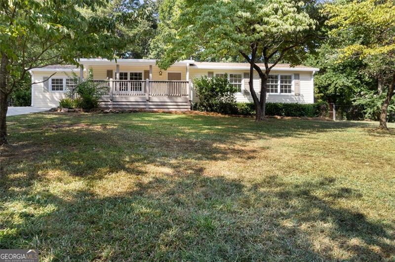 Prepare to be amazed by this beautifully renovated ranch home! Enter through the charming new rocking chair front porch and experience the open design of the expansive living room. The fireplace, featuring a single slab cedar rough cut mantle, radiates warmth and atmosphere. Step into the fully redesigned kitchen, which boasts brand new soft-close cabinets and drawers, stunning granite countertops with a subway backsplash, a deep pantry, and top-of-the-line stainless steel appliances. The separate dining area provides an excellent space for gatherings and meals. As you move down the hallway to the bedrooms, be sure to notice the convenient laundry room, which includes the finest tankless water heater available and space for a full-size stackable washer and dryer, along with a handy storage and hanging rack. Each spacious secondary bedroom features large closets, new fixtures, and ceiling fans. The generous primary suite offers double closets, lovely natural light from the double windows, a ceiling fan, and a full bathroom complete with an oversized luxury porcelain tile shower. Returning to the living room, you'll find a glass door leading to an expansive flex space, perfect for additional living area, an office, library, theater, or whatever your heart desires. Step outside to the freshly landscaped backyard oasis, where an inviting saltwater pool awaits, accompanied by a stylish new sun deck, elegant terracotta paving stones, and a concrete surround. Store your pool supplies and equipment in the newly enhanced pool house, equipped with multiple electrical outlets. On the front side of the property, you'll discover a vast storage and workshop area with power, a walk-through door, and a roll-up door. This home truly has everything you need to live, unwind, and enjoy homeownership. Now, let's discuss the materials used in the renovation: nothing is contractor-grade. The granite and backsplash are premium products personally selected by the seller. The LVP flooring throughout is of higher quality, scratch-resistant, and waterproof, rather than merely water-resistant. The gas tankless water heater is the finest on the market, manufactured by Navien. The HVAC system is brand new, including the furnace, AC, and ductwork. All door hinges, knobs, fixtures, and lighting have been upgraded to oil-rubbed bronze, and the trim throughout features all-new 4" door casings and 6" base trim. No expense was spared in this transformation. Centrally located near Macland Rd (Kroger, restaurants, shopping), Dallas Hwy (Publix, restaurants, banks, medical facilities), and Hwy 278 in Hiram (everything you need!), you're just 35 miles from Hartsfield-Jackson International Airport. There's so much to love about this home. Act quickly to make it yours!  Some photos have been virtually staged.