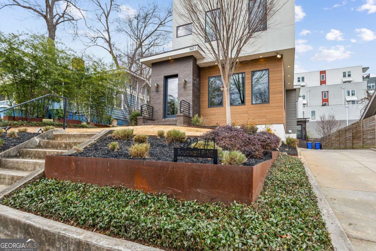 Tucked in the heart of Atlanta's buzzing Old Fourth Ward, this show-stopping Jackbilt resale combines sleek modern luxury with unbeatable city living. Just moments from the Beltline, this stunning front-unit, 3 bedroom, 3 bath, duplex dazzles with light-filled interiors, wide-plank hardwood floors, and stylish finishes throughout. The gourmet kitchen is made for entertaining- stone countertops, a walk-in pantry, and a dramatic two-sided fireplace that connects seamlessly to the living room for cozy nights in. But the real jaw-dropper? A private rooftop sky lounge that's nothing short of spectacular-Trex decking, a built-in outdoor kitchen, commercial ice maker, half bath, and panoramic views of Ponce City Market. Green thumbs will love the lush, landscaped front yard perfect for gardening, while the 2-car garage with custom-built storage loft keeps everything neat and tidy. Impeccably crafted, endlessly stylish-this is city living at its finest!