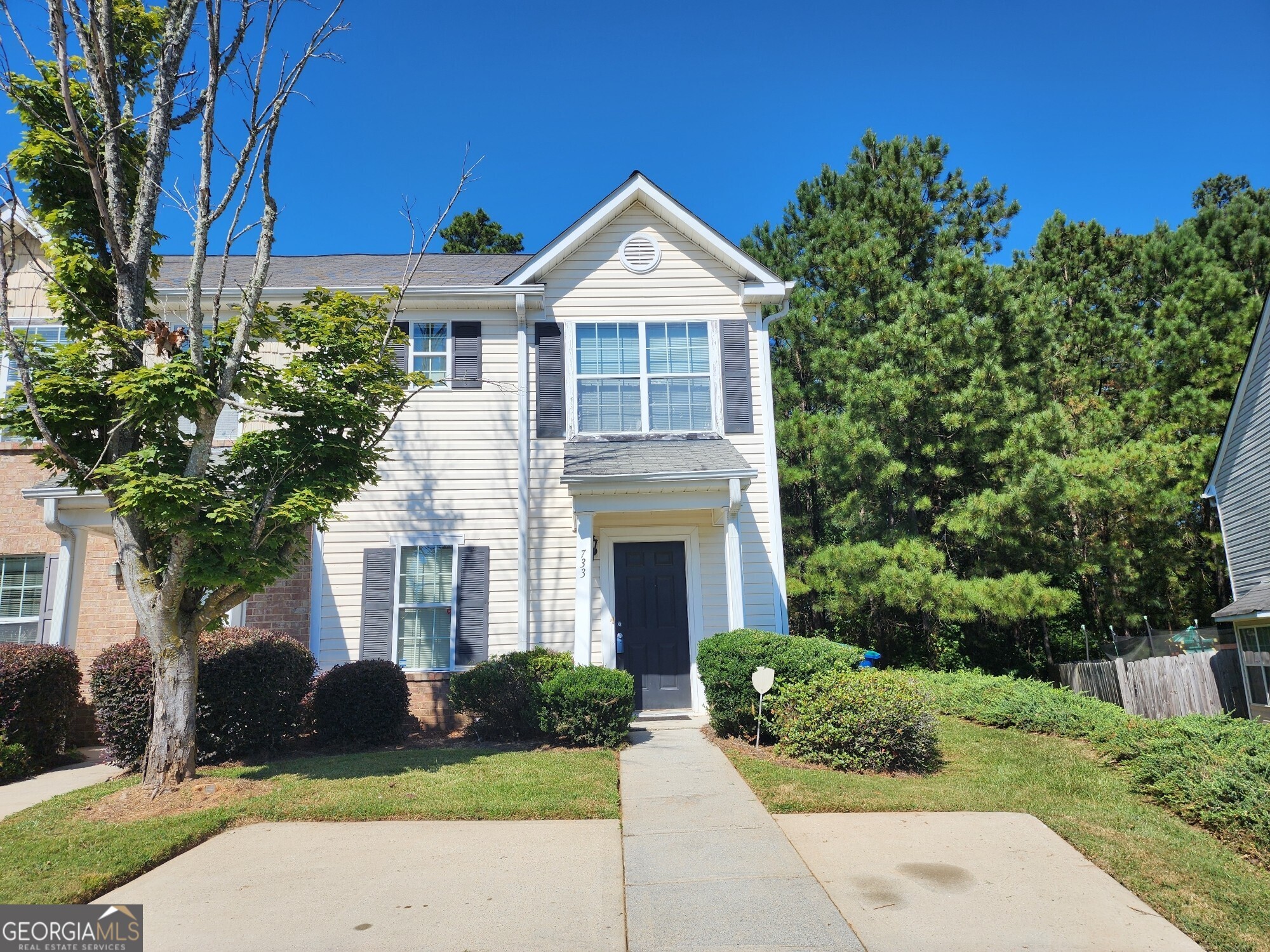 Welcome to a lovely two-story townhome nestled in a charming, tree-lined community. The main level boasts warm timber flooring and an open, sunlit floor plan that flows seamlessly throughout. The kitchen features granite countertops, a black appliance package, and opens to a separate dining area with sliding glass doors that lead to a private back patio perfect for relaxing or entertaining. Upstairs, you'll find a well-designed roommate floor plan with spacious bedrooms, each offering walk-in closets, wall-to-wall carpeting, and private en-suite bathrooms for added comfort and privacy. Additional highlights include off-street parking and a prime location with convenient access to local amenities.