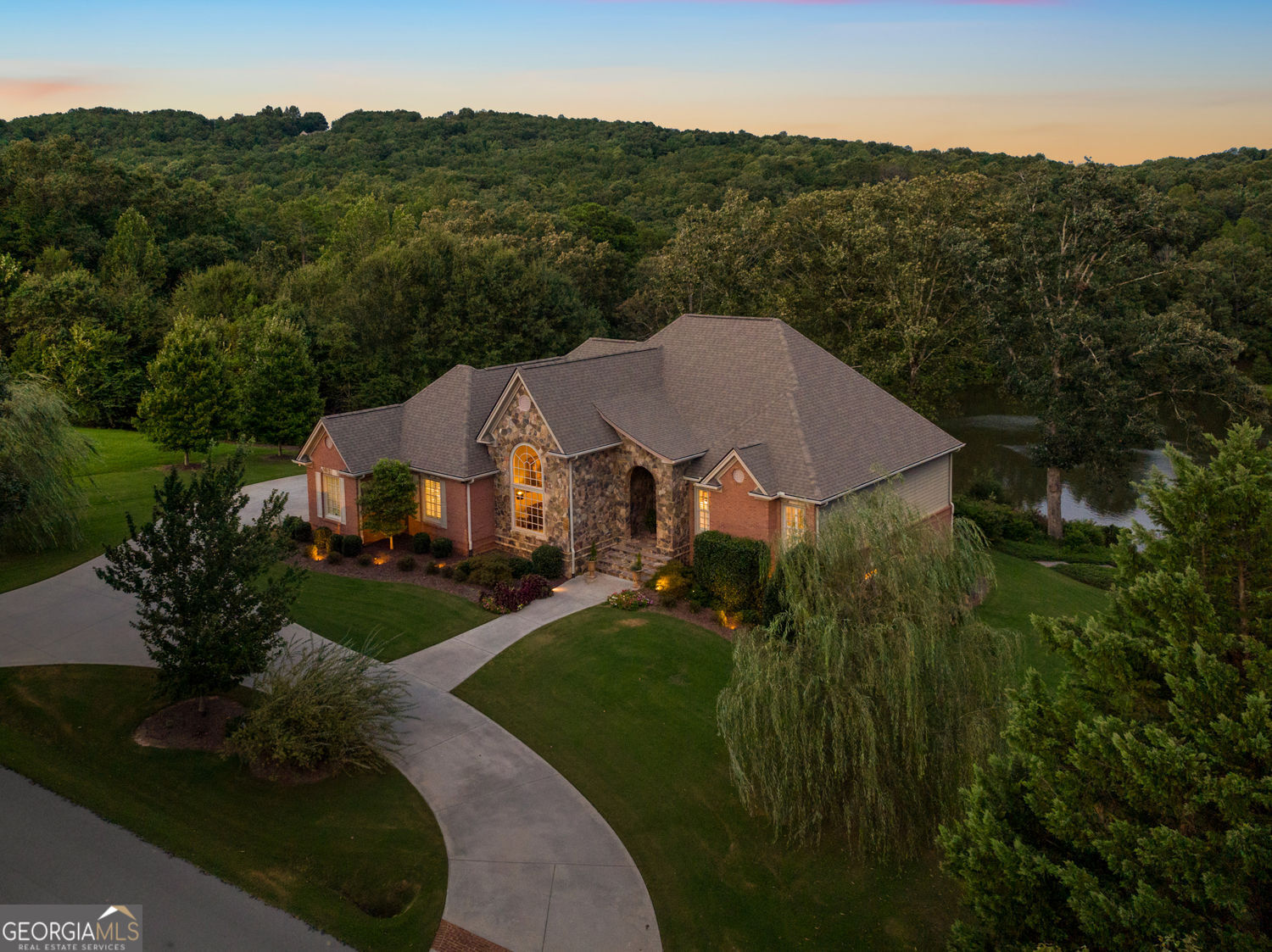 Updated 4BD, 3.5BA, 5592sqft Executive Lakefront Home in The Orchard Golf Community! Incredible finishes inside and out with 2 fireplaces, towering vaults and trayed ceilings, deep crown mouldings, wide-plank oak floors, 8' doors, plantation shutters, and designer fixtures. The home has beautiful natural light and flows effortlessly between comfortable living areas. The layout features a grand entry, separate dining / parlor room, living area, keeping room, covered and vaulted screened porch and grilling deck overlook the lake. Gourmet kitchen has island with prep sink, granite tops with bar seating, breakfast area, and beautiful glazed custom cabinets. Massive owners' wing has recessed soaking tub, tiled shower, his and hers vanity, and his and hers custom walk-in closets. Terrace level has 10' finished ceiling height with two full bedrooms each with en suite bathrooms, living room with built-in bar, safe room, workshop / home gym / storage area and screened veranda. Plus, oversized 2.5-car garage with workbench and sink, professional landscaping, landscape lighting, irrigation, and whole-house sound system. The property is 2.08 total acres composed of two lots and with over 300' of lake frontage and stationary dock. Waters Lake is a beautiful 8.5 Acre Private Lake perfect for wildlife viewing, fishing, paddling and swimming! Among the best of the best in The Orchard! The Orchard is a friendly and vibrant private golf club community in the beautiful mountains of Northeast GA with gated access and 24-hour security, championship golf course, newly renovated clubhouse, pool and brand new tennis and pickleball amenities. Convenient to Clarkesville, Tallulah Falls and Clayton and only 90 miles from Atlanta.