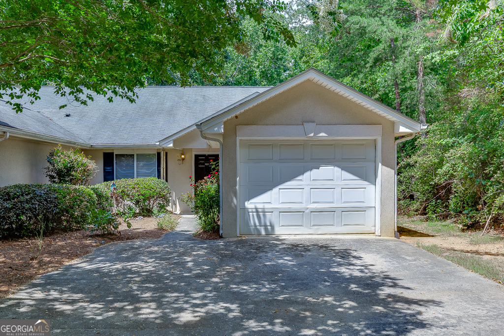 Welcome to this charming 2 bed, 2 bath end unit home offering privacy, convenience, and exceptional value. Nestled in a peaceful, wooded setting, this well-maintained property features a bright, open floor plan with vaulted ceilings, spacious living and dining areas, and a functional kitchen with generous cabinet space. Enjoy the ease of single-level living, a one-car garage, and a private back patio that's perfect for relaxing or entertaining. The oversized laundry room and ample closet space add to the home's practicality. Located just minutes from Lake Lanier, local parks, downtown Gainesville, and the Dawsonville outlets, this home offers unbeatable access to shopping, dining, and outdoor recreation. Plus, with no rental restrictions, it's a great option for homeowners and investors alike. Sold as-is, this move-in-ready gem is a rare find at this price point, don't miss out!