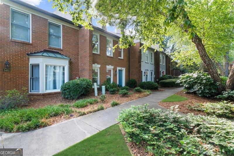 Enjoy quiet living amongst a beautiful tree-lined landscape in this freshly RENOVATED move-in ready brick beauty. Spacious 2 bed/2.5 bath home located in ideal Duluth location, right on the cusp of Johns Creek and short drive to Downtown Duluth, so many resturants, shopping, Chattahoochee River Park, walking trails and easy access from Peachtree Industrial to Pleasant Hill/120 and 85. You won't have to lift a finger. Renovated kitchen with brand new refrigerator, newer appliances, updated cabinets and more! New paint and new carpeting throughout. Brand new HVAC & hot water heater. This home has a great open layout as well with spacious living room area with cozy fireplace, oversized dining area off kitchen, lots of cabinets and counter space in the kitchen, extra large half bathroom with laundry area included on main level. Upstairs has a great roommate/split bedroom plan with two generously sized rooms each with great closet space, ensuite to large bathrooms one with a tub/shower combo and the other with a shower only. Plus enjoy nice outdoor space with private back patio adjacent to extra large carport and enchanting green space in the front including a lovely gazebo. This community includes so many ameniites: pool, tennis courts, lake with surrounding beautifully landscaped walking trail, lots of guest parking. HOA covers all of this and all exterior maintenance including roof repair, gutter cleaning, landscaping, pest control, termite and so much more. PLUS investment opportunities still currently available, rental cap has not been met. Don't miss this opportunity to make this inviting townhome your own!